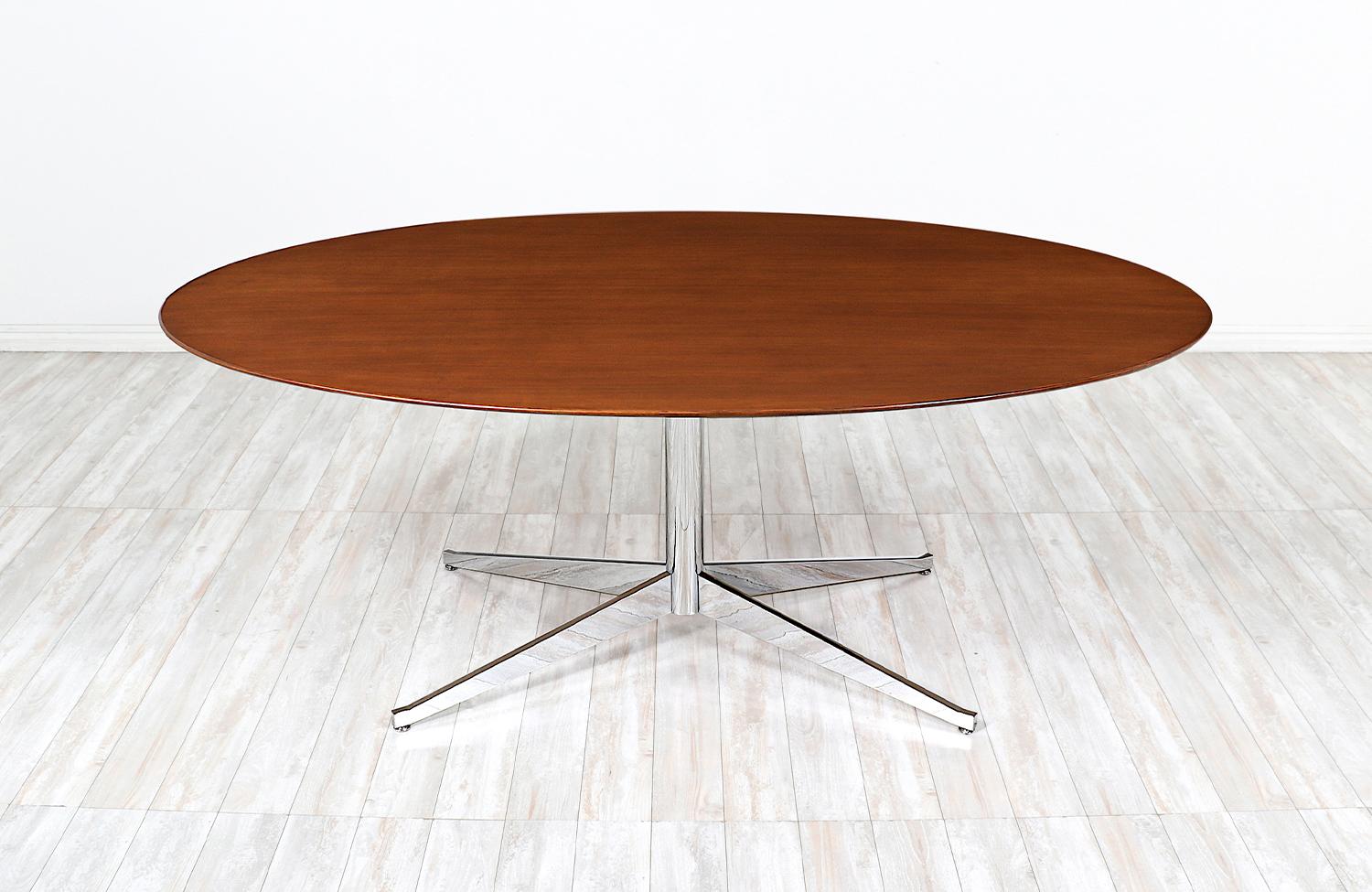 Vielseitiger Tisch, entworfen von Florence Knoll für Knoll International in den Vereinigten Staaten, ca. 1960er Jahre. Dieses ikonische Design zeichnet sich durch eine ovale Platte aus massivem Walnussholz aus, die auf einem verchromten