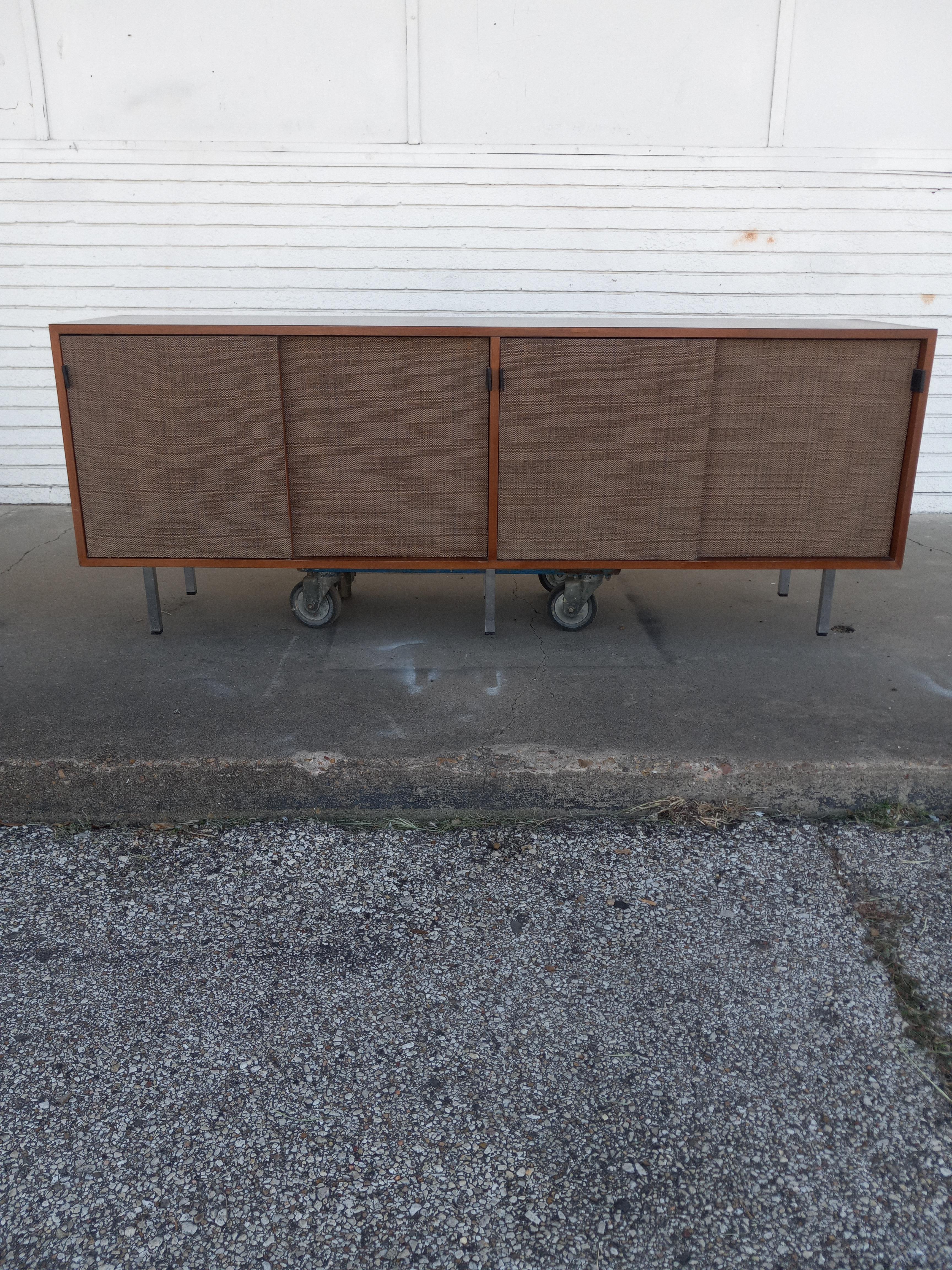 Scarcely seen early 1950's walnut credenza. So many marvelous features include four caned doors with leather pulls, two generously sized drawers, side bar with spacious cabinetry & work surface boasting all original hand rubbed finish. Beautifully