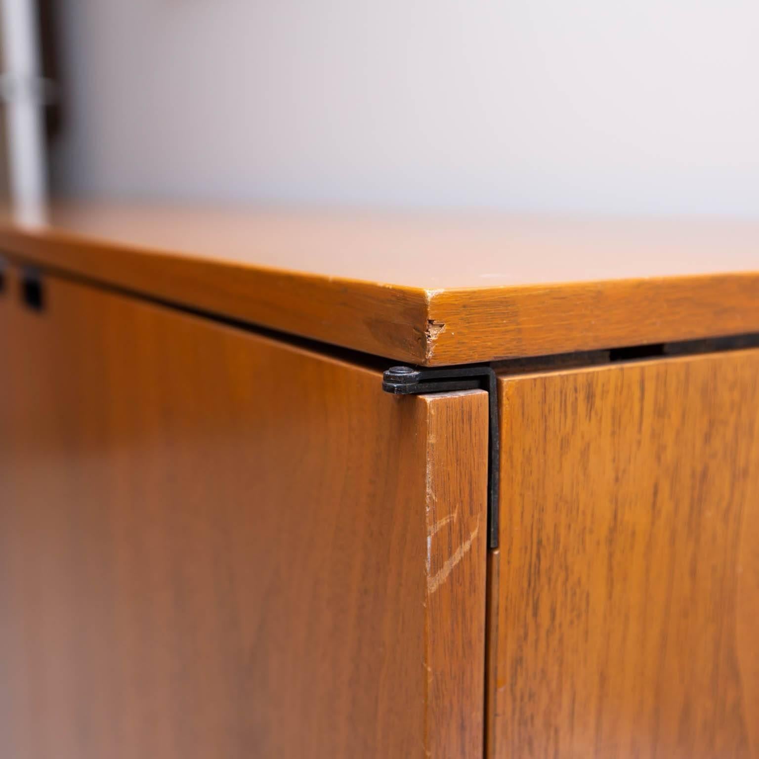 Walnut office credenza resting on a chrome base. The interior has four storage areas with one adjustable shelf in each section. Two sides are lockable with original keys.