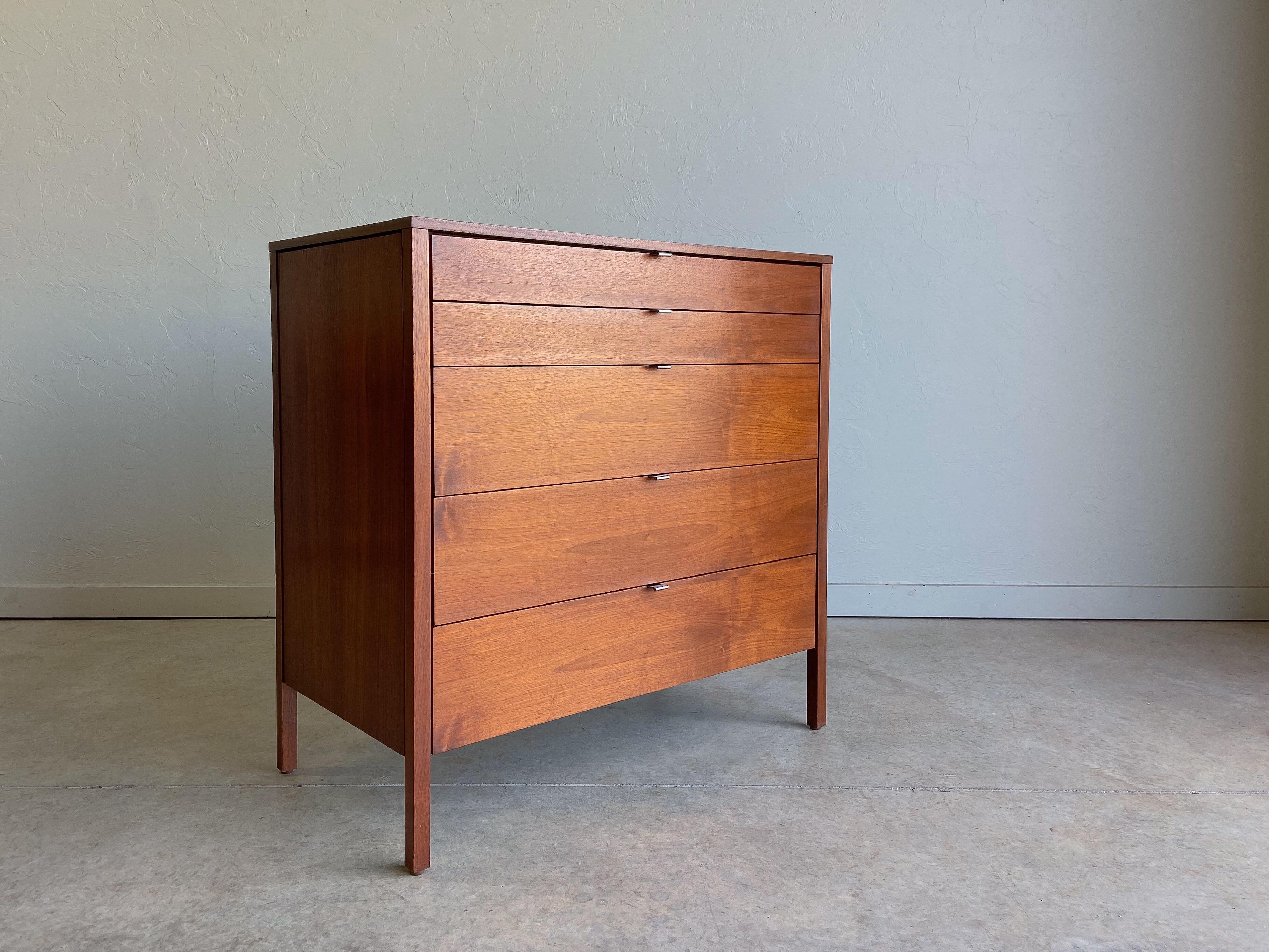 Offered is an early dresser or chest of drawers designed by Florence Knoll for Knoll International.

Beautiful walnut grain throughout. Retains the original chrome drawer pulls. Five drawers provide ample storage in a compact design.

