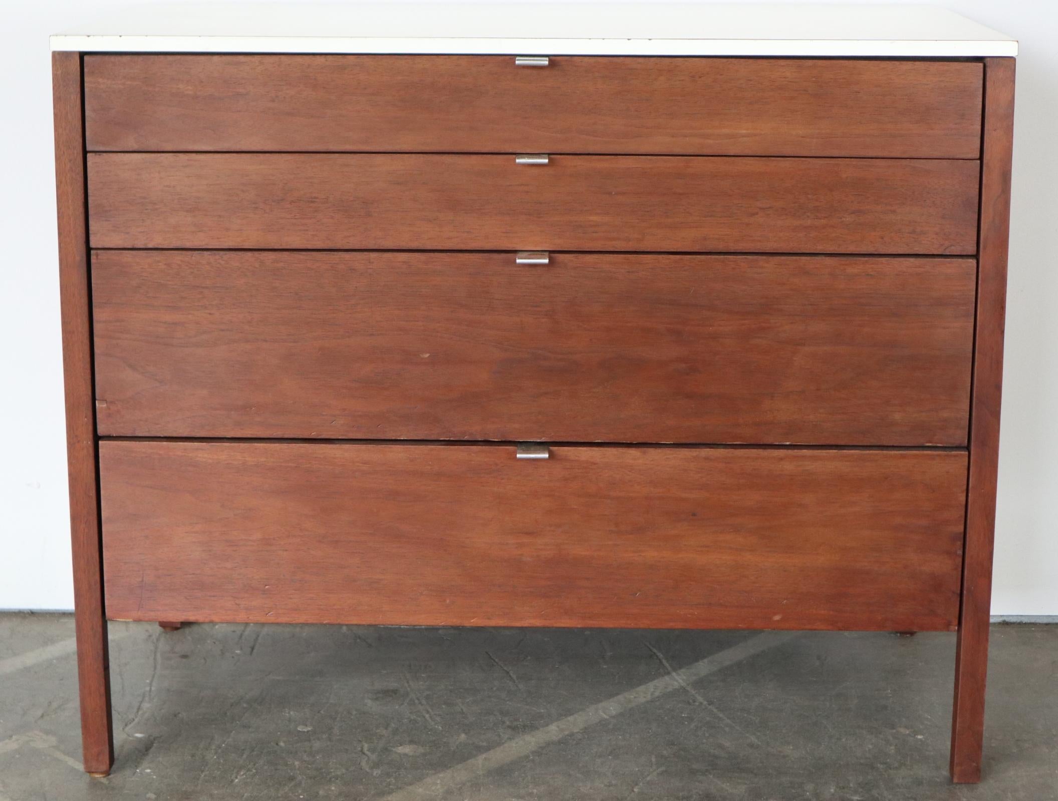 Early Florence Knoll dresser in walnut and laminate top. Wood refinished and is stunning. Original pulls and bow tie label. Drawers function smoothly. Top in great shape for the age. Minor wear. Presents very well.