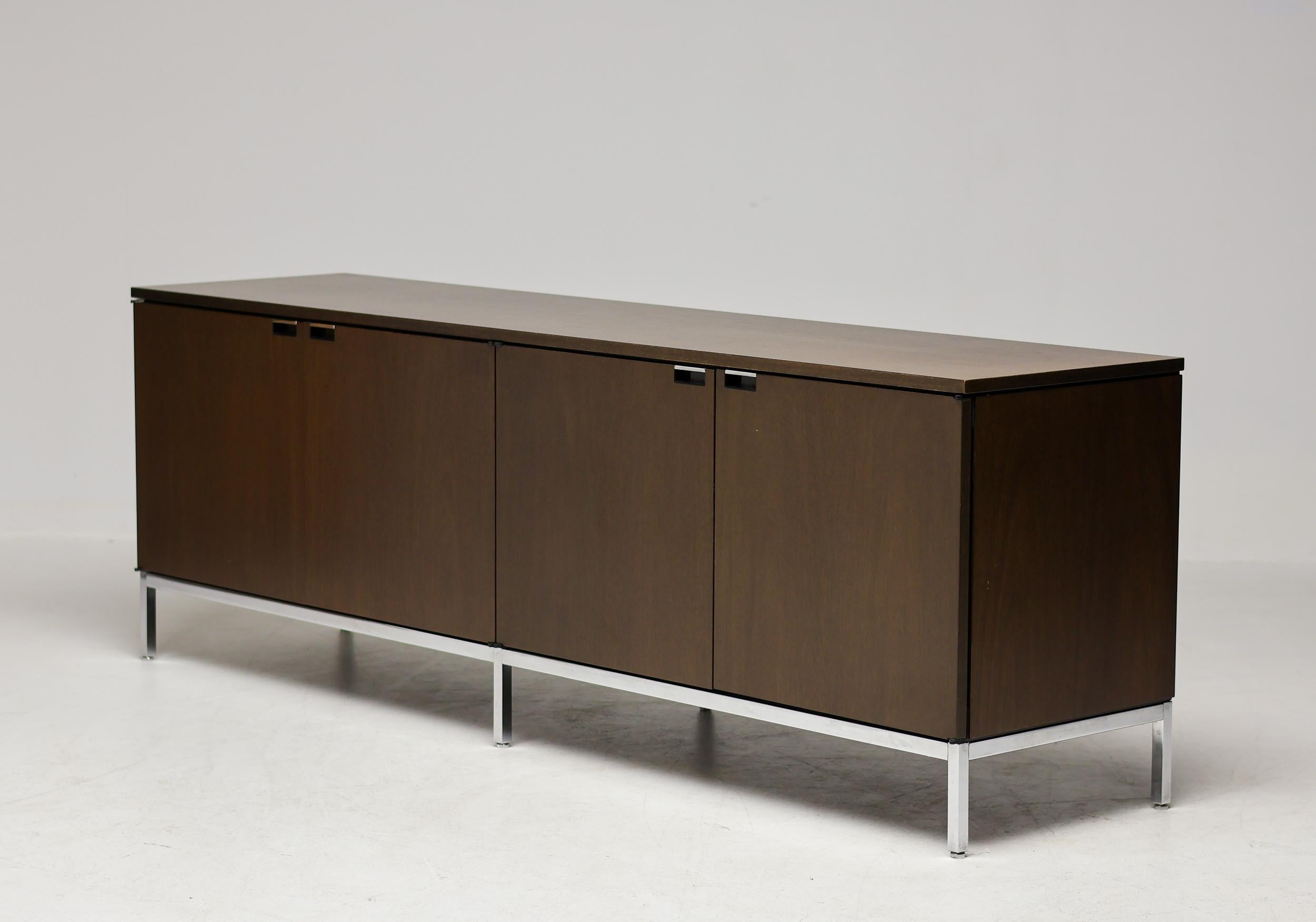 Beautiful Florence Knoll cabinet by Knoll International. The dark European walnut contrasts elegantly with the chromed steel frame and door handles. Ample shelving in matching walnut.

Provenance: 
The office of the ceo of a large multinational in