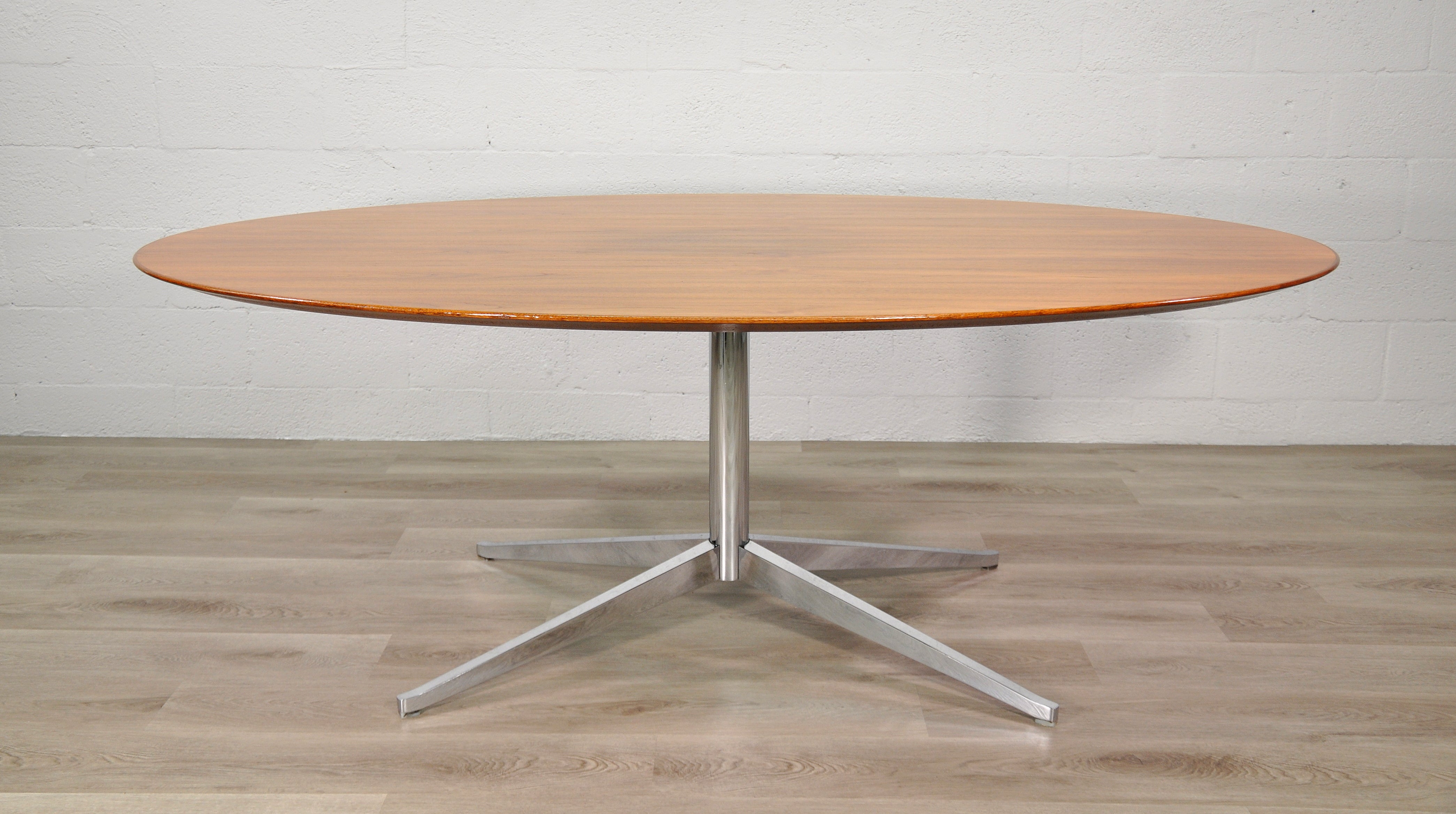 Versatile 2480 pedestal table desk designed by Florence Knoll for Knoll International in the United States, dating from the 1960s. This iconic design features a solid oval walnut wood top that sits over a welded steel base with polished chromed