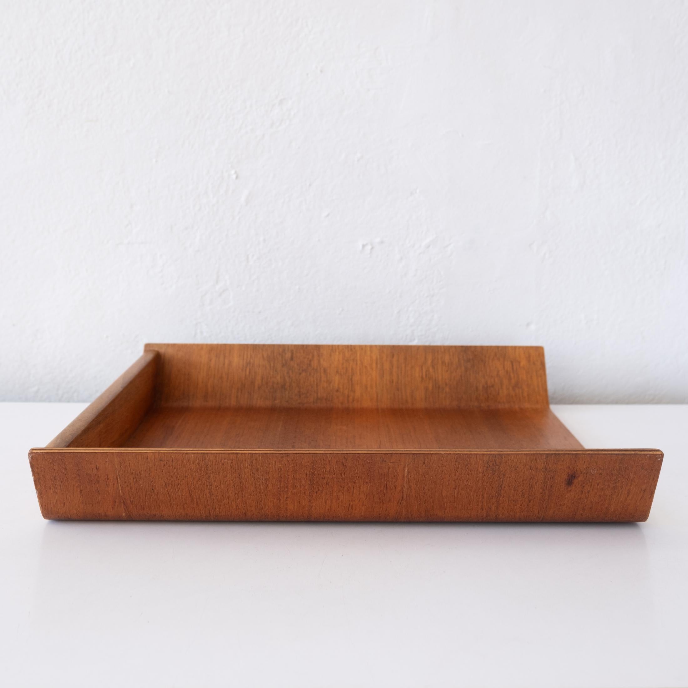 Letter tray designed by Florence Knoll for her company, Knoll. Designed in 1948. Formed bent ply  walnut. Retains the original older Knoll label with Herbert Matter logo.  
