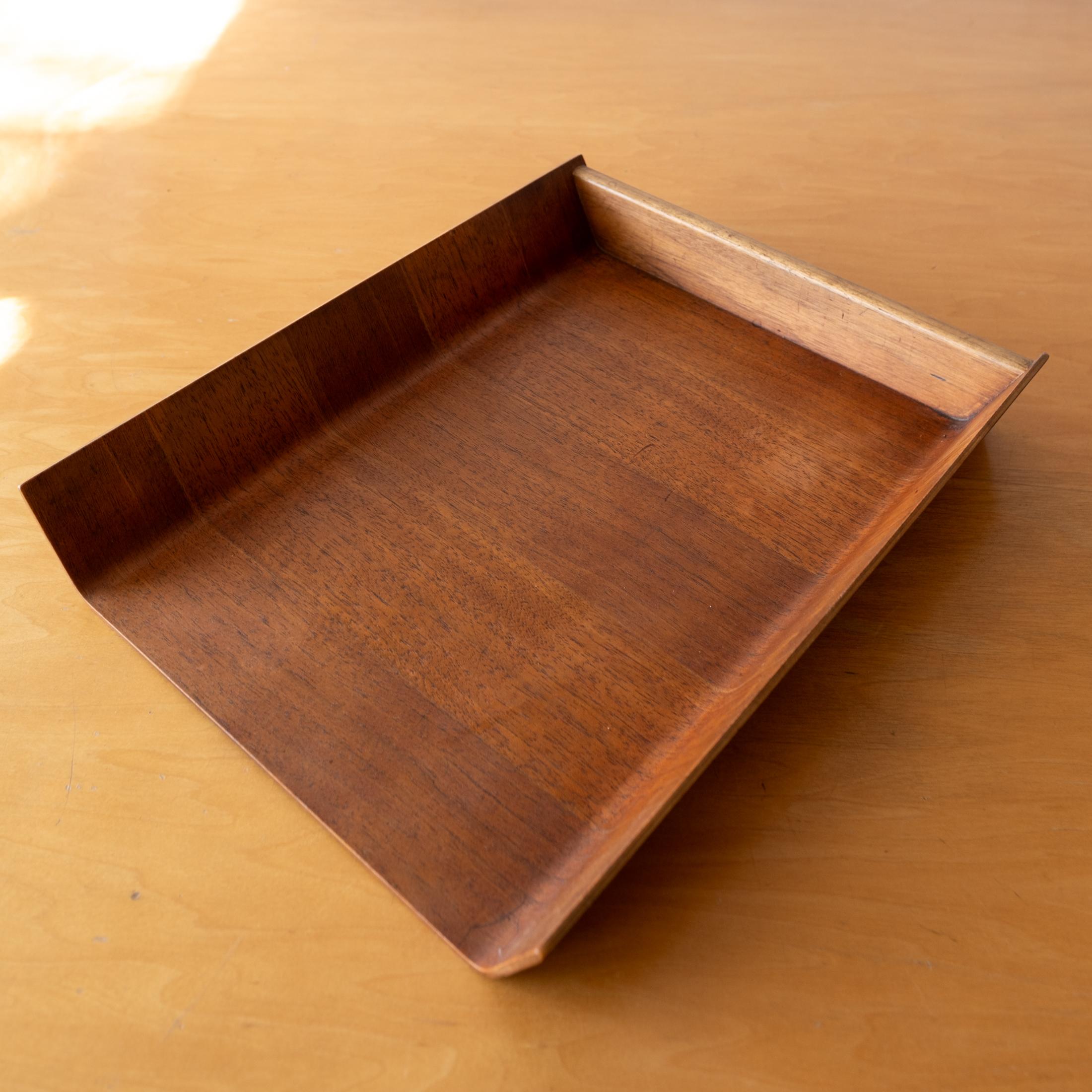 Letter tray designed by Florence Knoll for her company, Knoll. Designed in 1948. Formed bent ply  walnut. Retains the original older Knoll label with Herbert Matter logo.  
