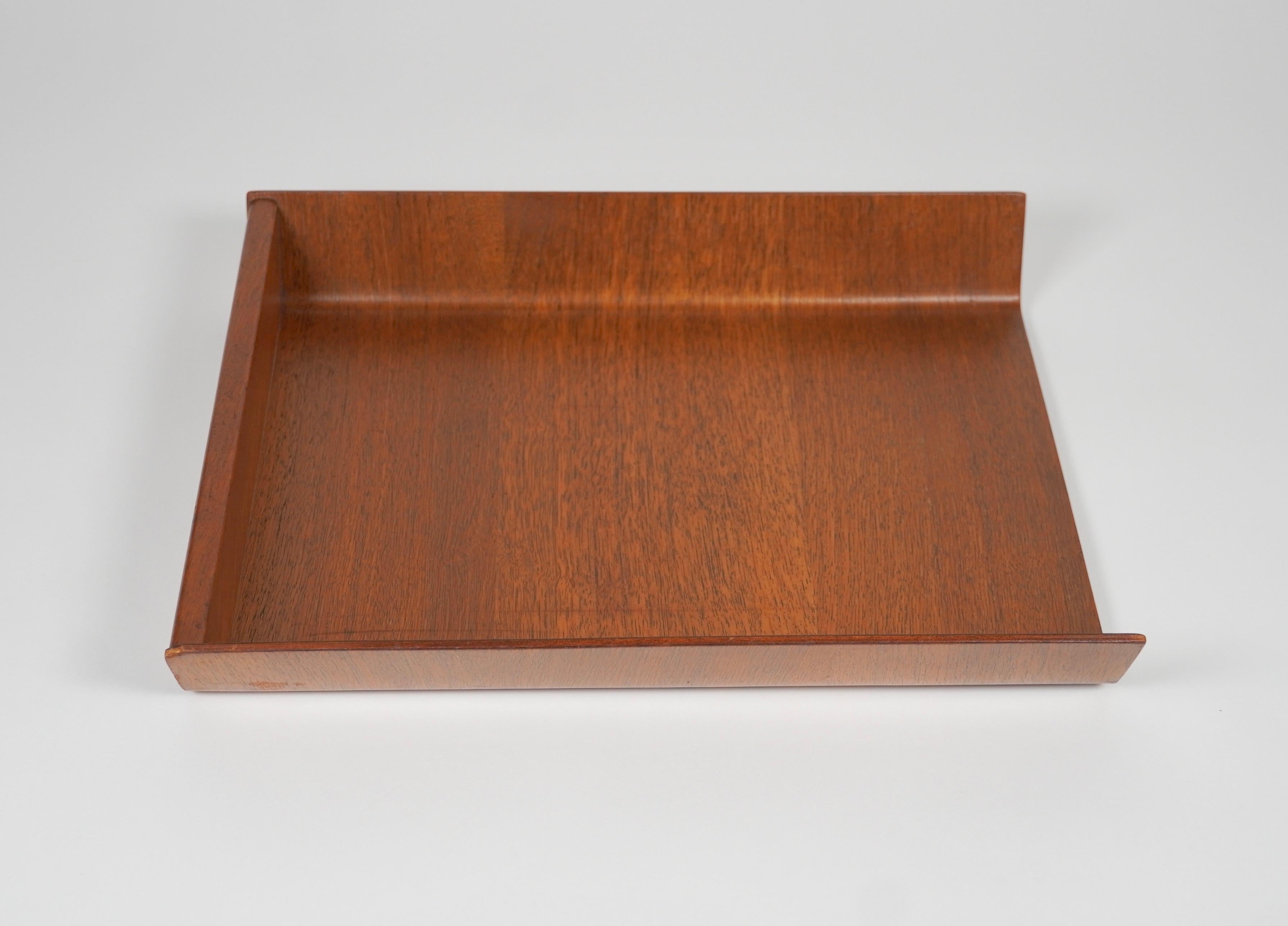 Designed by Florence Knoll in 1948, this letter tray is made of walnut plywood and was a staple of midcentury office decor. The underside bears the fabric Knoll label with 320 Park Avenue pre zip code address, indicating manufacture 1950s to pre