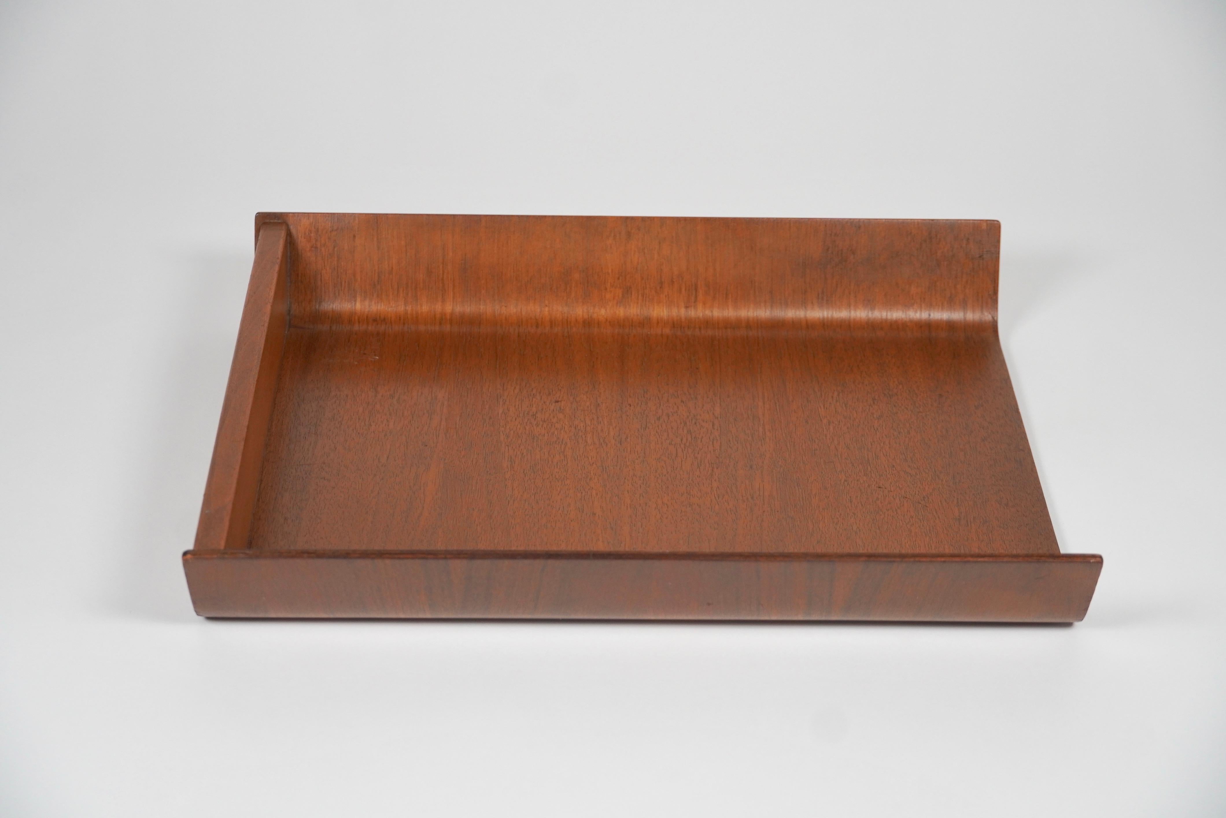 Designed by Florence Knoll in 1948, this letter tray is made of walnut molded plywood and was a staple of midcentury office decor. The underside bears Knoll Associates label, pre 1969 with the 320 Park Avenue address, indicating manufacture in the