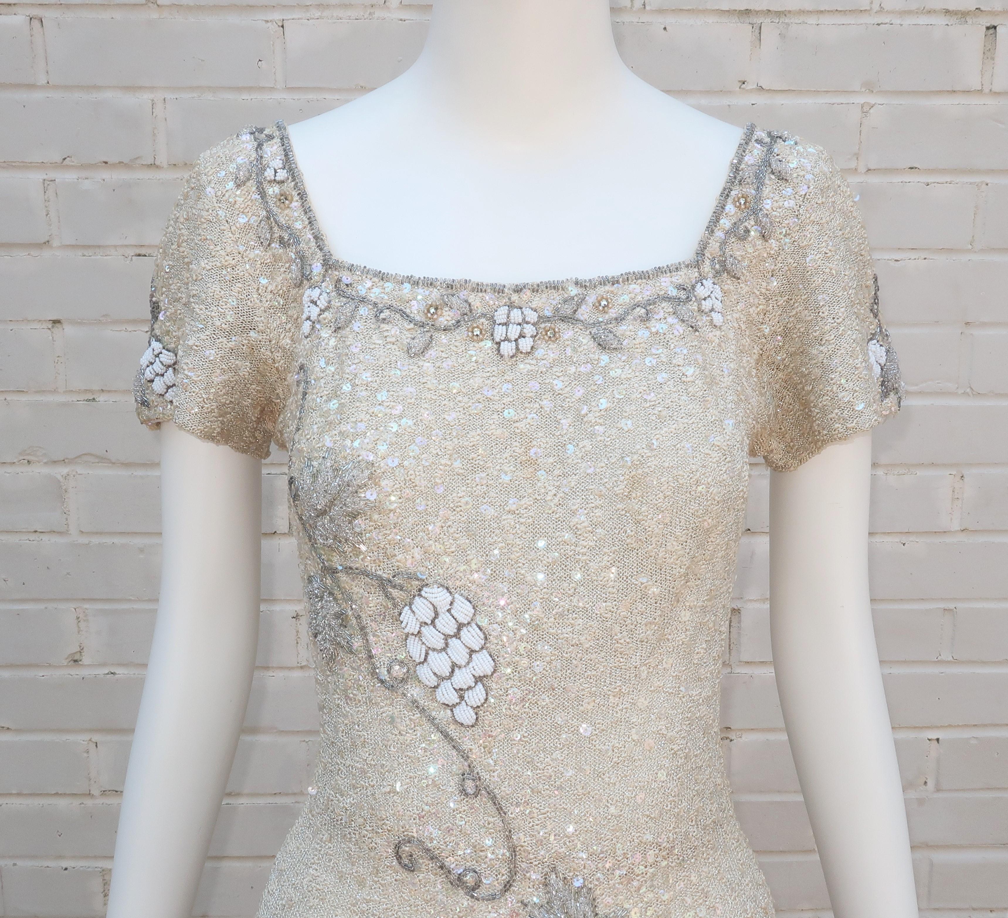 A glamorous 1950's Florence Lustig knit wear dress with shimmering all over sequins and elaborate beading in the form of a grape vine.  The off-white knit has a silvery Lurex sparkle and nubby style finish which provides a body conscious silhouette