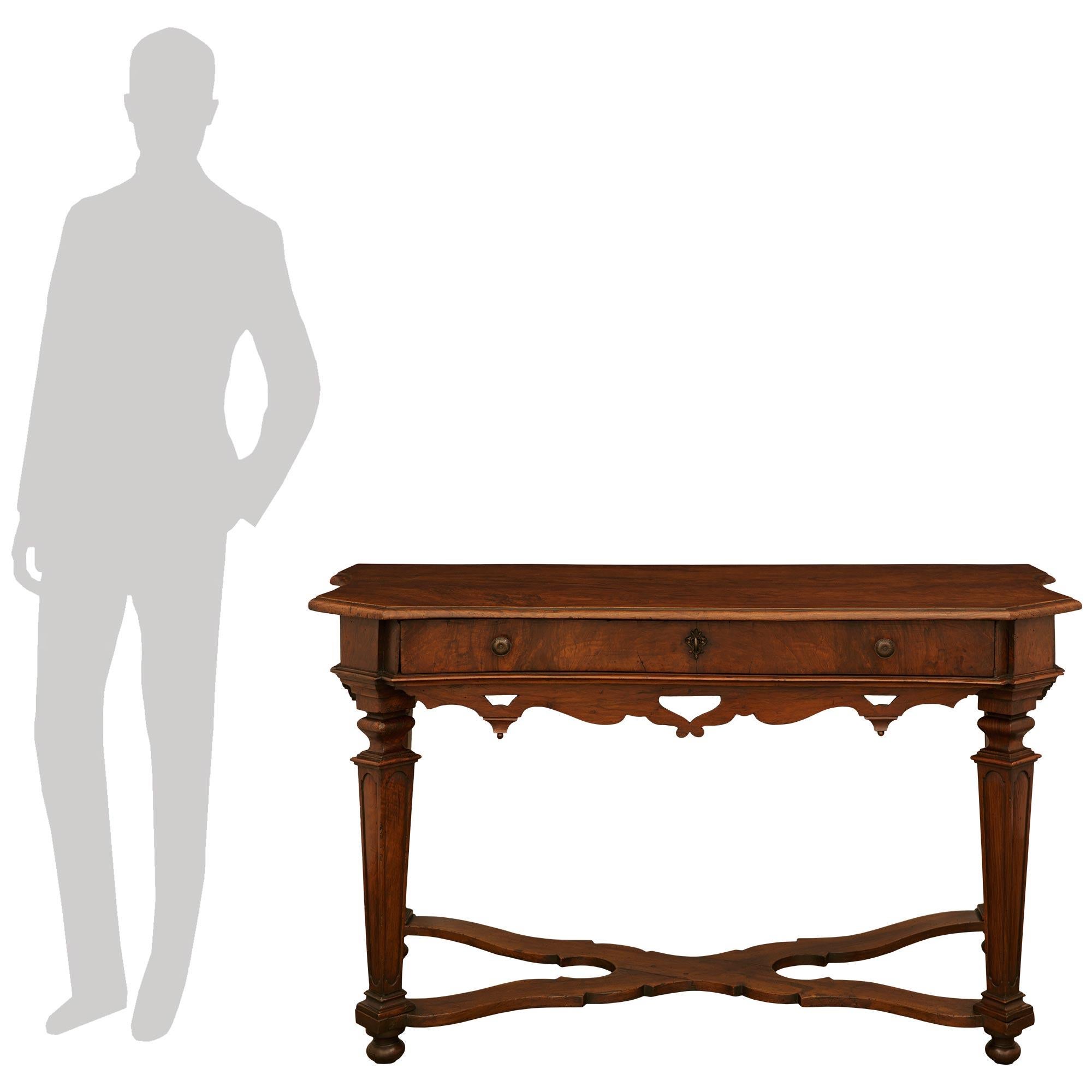 A handsome and most unique pair of Florentine 17th century Louis XIV Period Walnut and Bronze consoles/center table. This wonderful pair of consoles from Florence are raised on toupie shaped feet below the tapered legs displaying recessed panels on