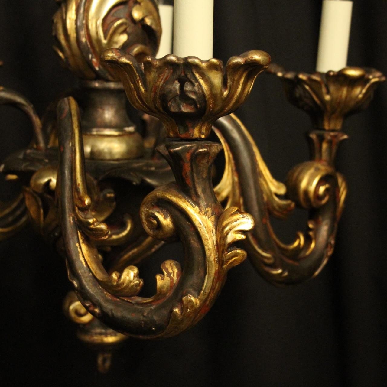A quality Italian giltwood Florentine 5-light antique chandelier, the ornate scrolling arms with pierced carved leaf wooden bobeche drip pans, issuing from an leaf carved wooden baluster central column, having the original chain and ceiling rose,