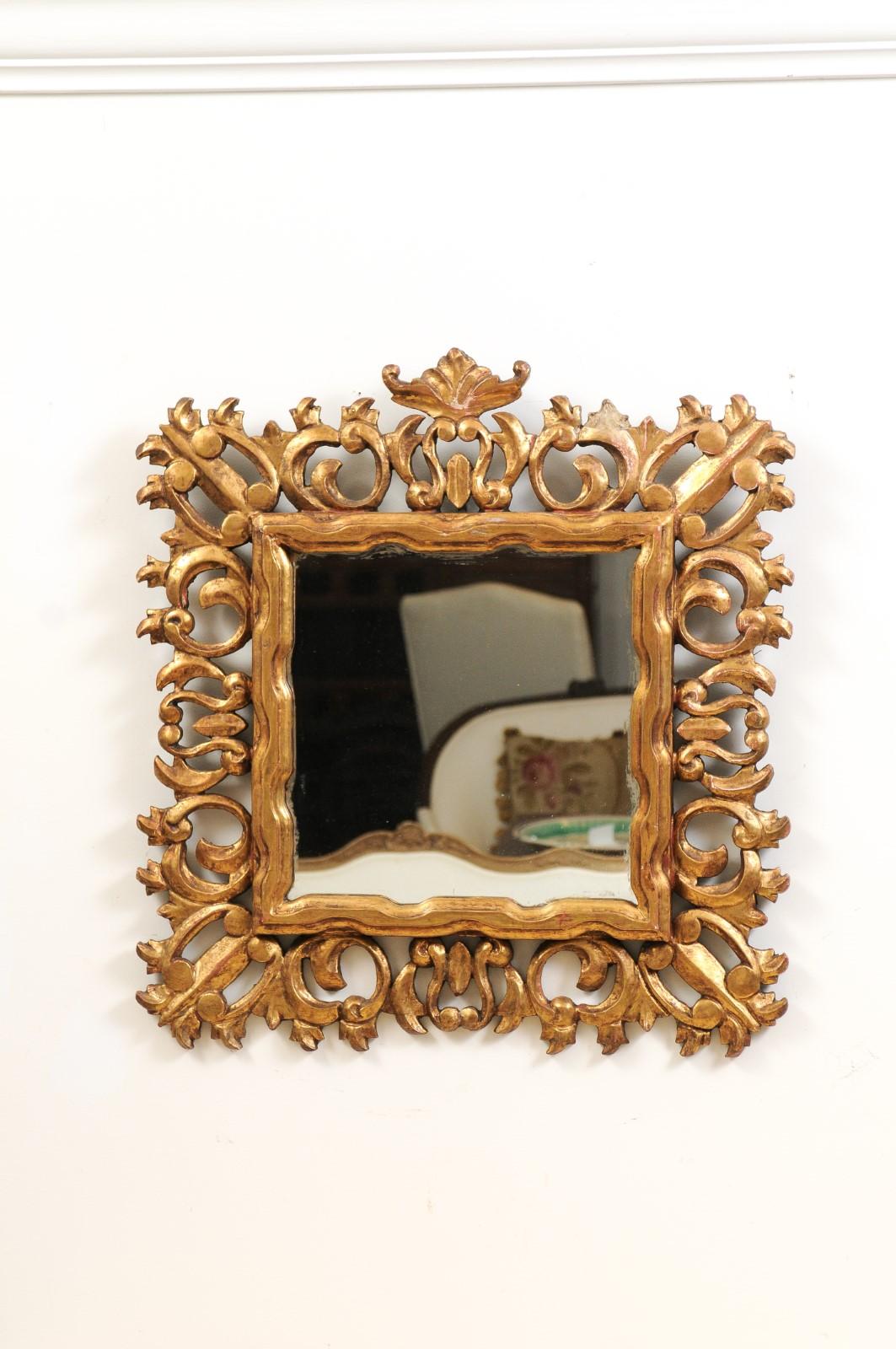 An Italian Florentine wall mirror from the 20th century, with carved giltwood frame. Created in Florence during the 20th century, this Tuscan mirror features a clear rectangular mirror plate surrounded by a faux-bois inspired inner molding. It is