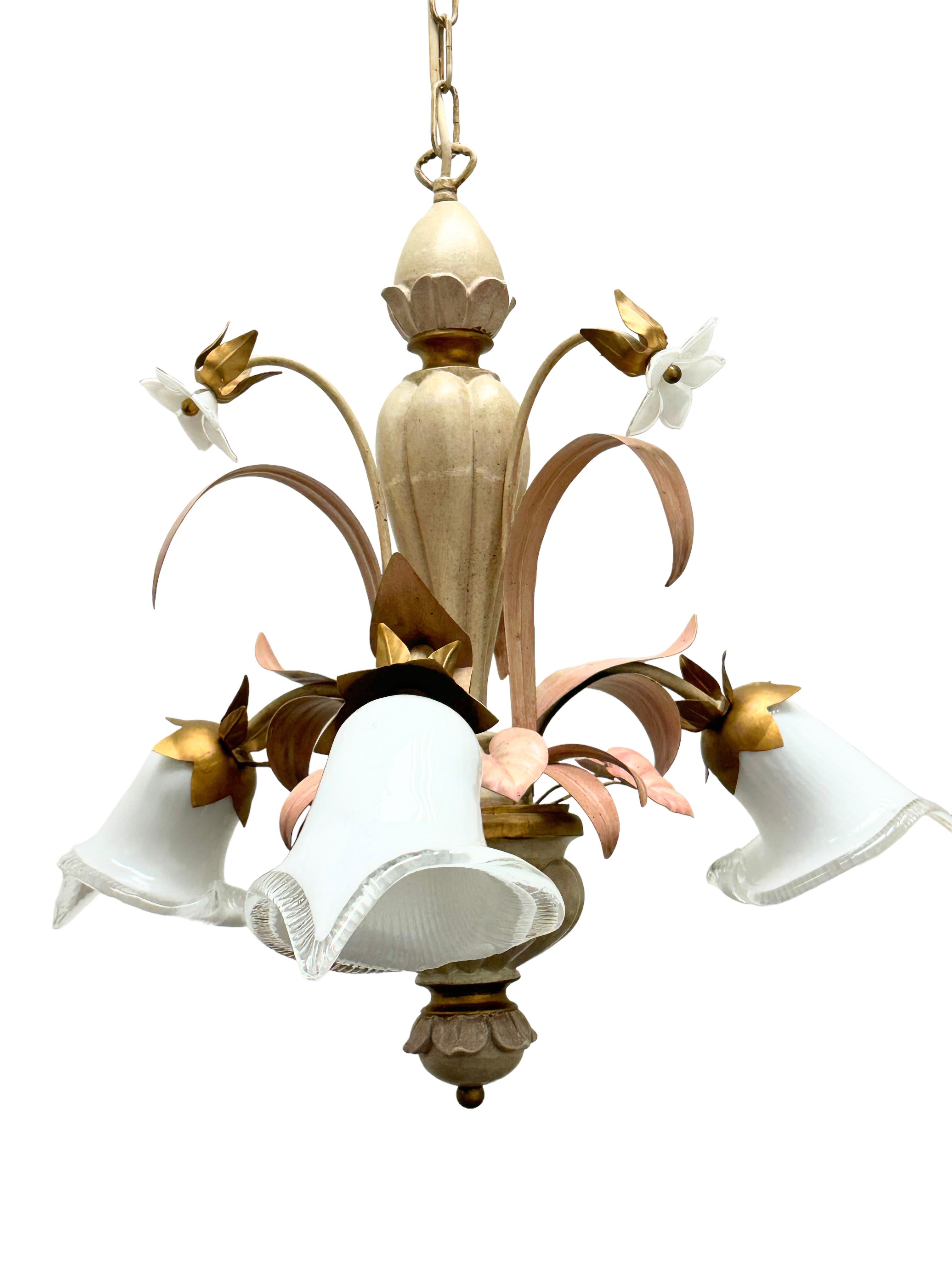A beautiful chandelier with three lights that was made in Austria, by Eglo Leuchten, circa 1980s.
The chandelier is made in polychrome hand carved wood and metal, with glass shades. The color combination of the chandelier is very special and it