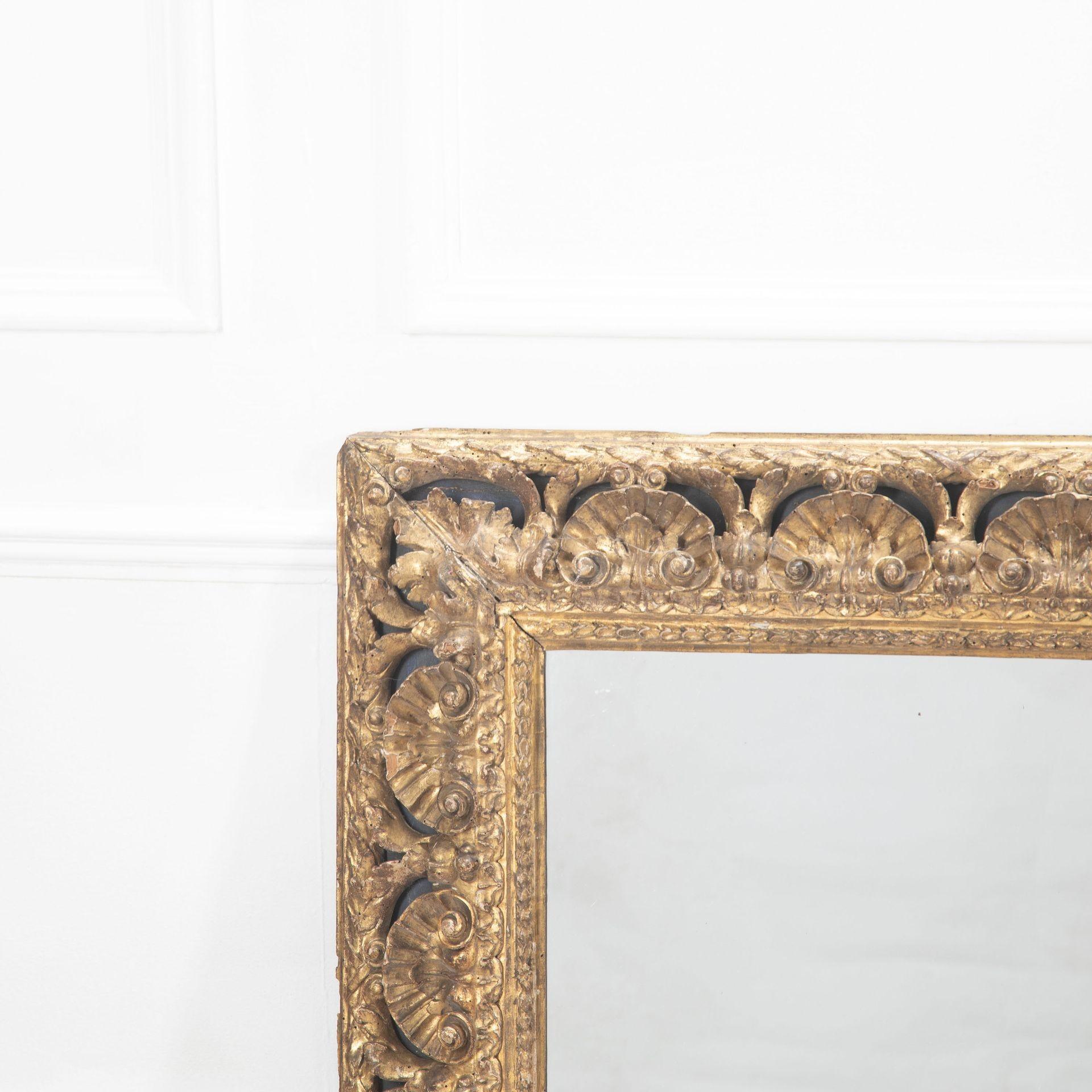 A beautifully carved and gilded frame with large shell decoration and later mirror plate.
With small loss to carving in one corner and some restoration to the back of the frame, commensurate with age.
