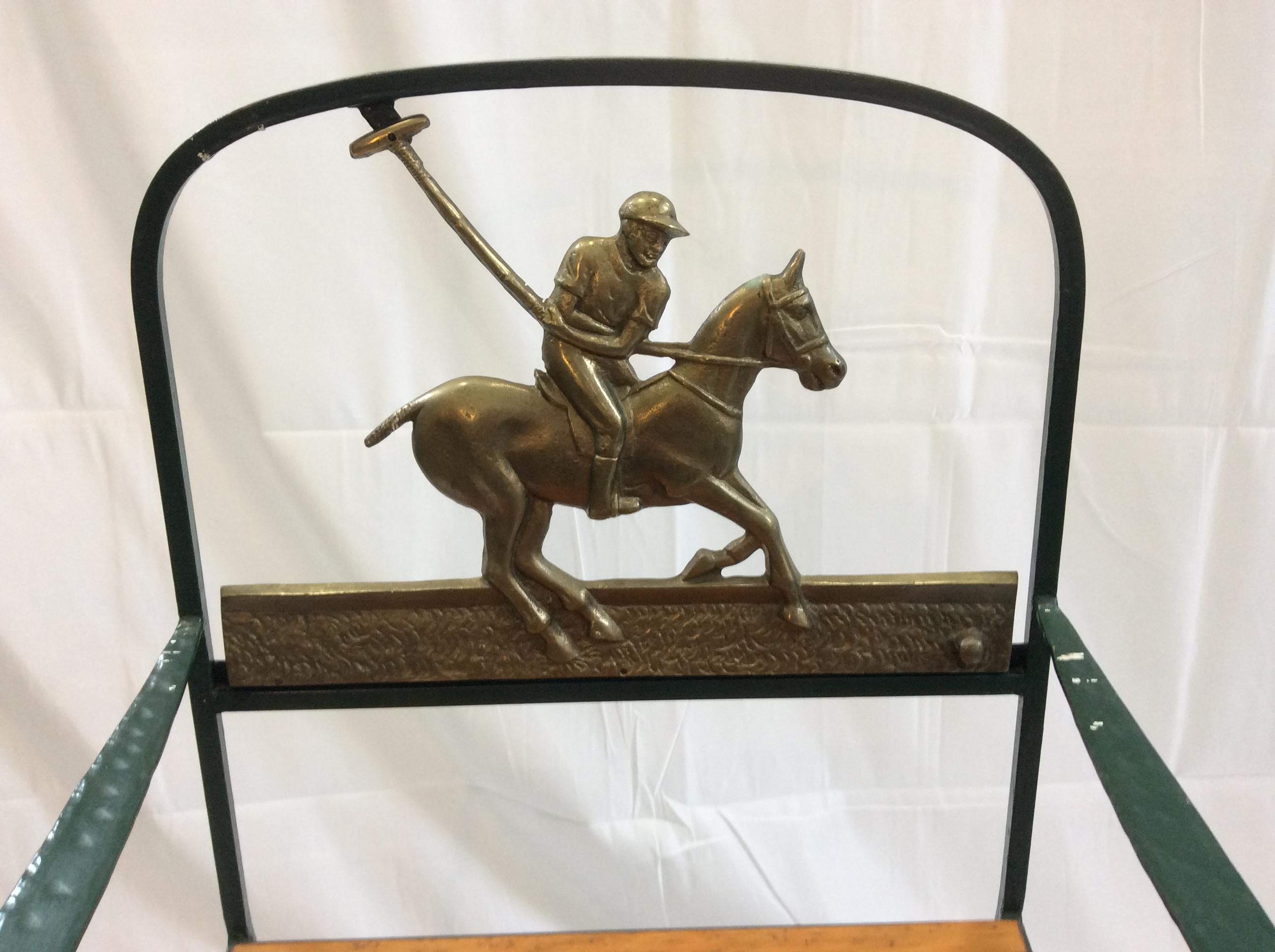 Cast brass polo player back, heavy wrought iron chair frame.
Wooden slat seat, square shaped legs on round pad feet.
Flat dimpled arm ending in a simple scroll. Made by Florentine craftsmen in long island city... These designs were sold through MJ