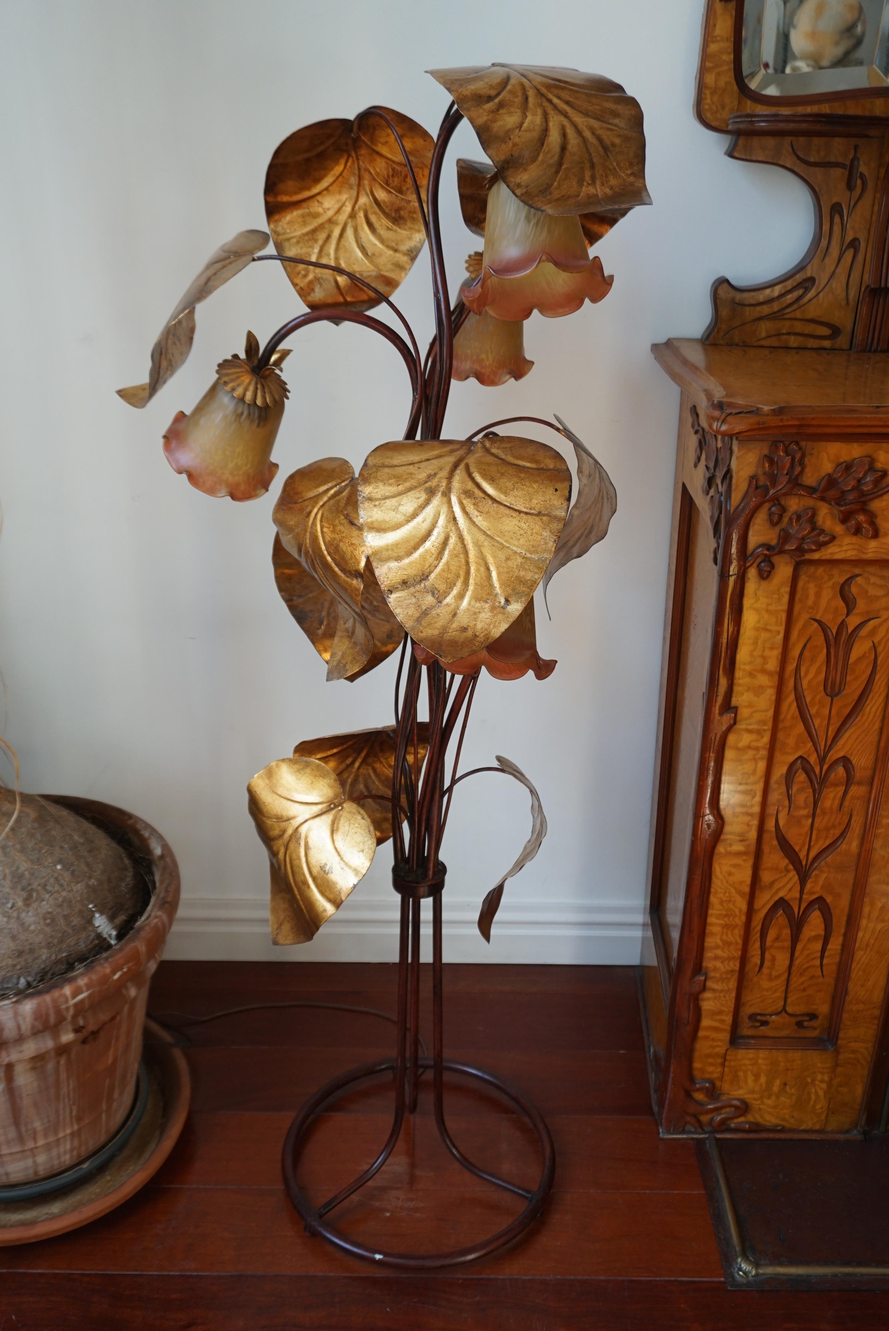 Florentine gilded metal floor lamp with colored glass chalice-shaped shades.
Hans Kögl style 1970s

This rare lamp features 4 light points and has 11 beautiful golden metal leaves. By the gold reflects the light beautifully and gives a very nice