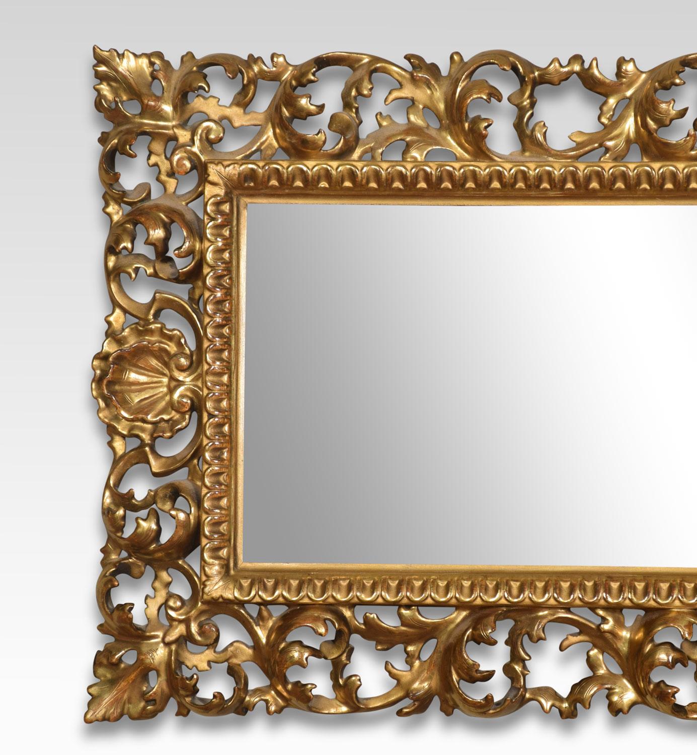 Florentine giltwood wall mirror, the original rectangular mirror plate surrounded by scrolling leaf and shell carved frame.
Dimensions:
Height 16 inches
Width 38 inches
Depth 2 inches.