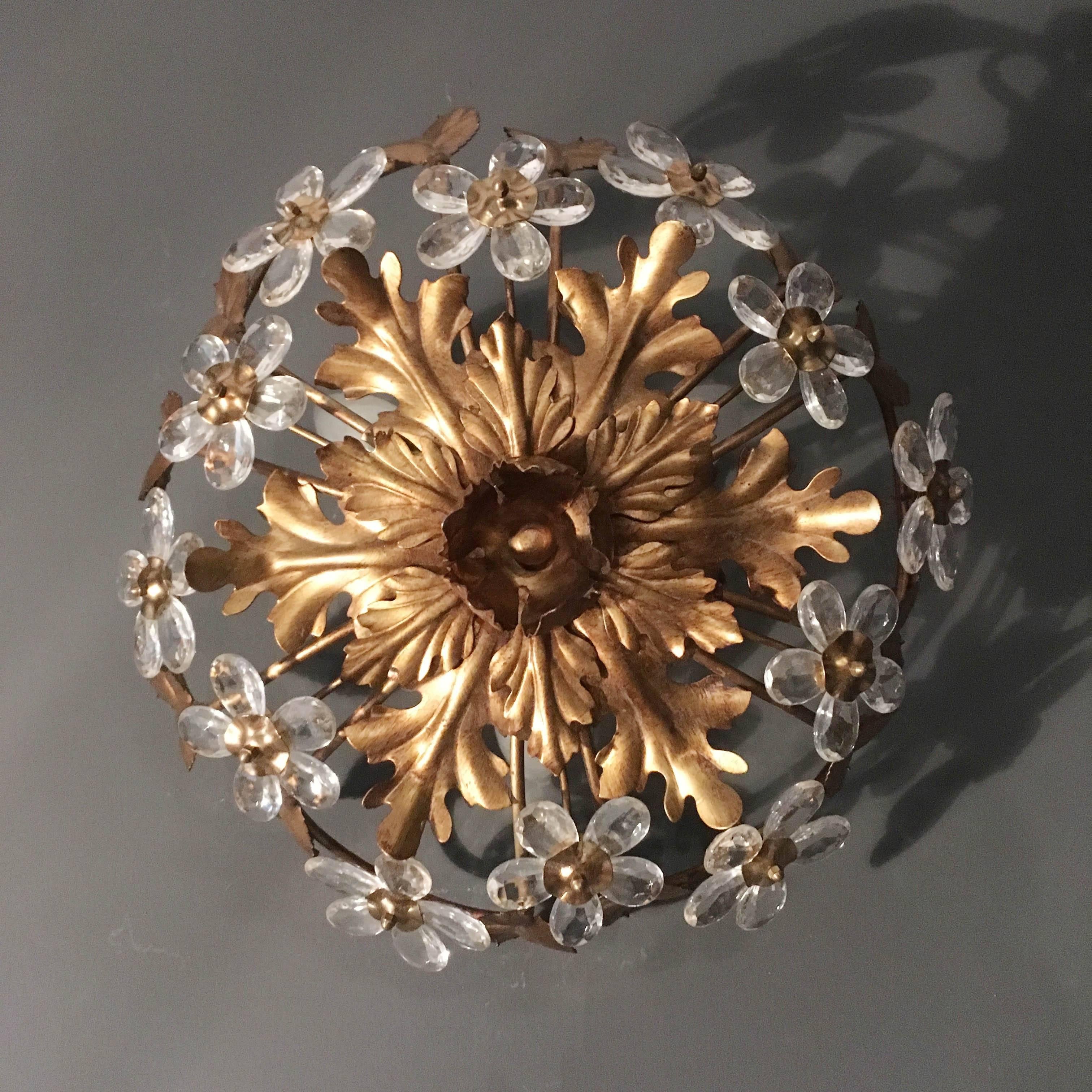 Florentine glass flower flush ceiling light

Stunning leaf and flower design ceiling light, brass colored metal leaves interspersed clear cut-glass flowers.

The light has three bulb holders, these take standard size screw in bulbs

The light