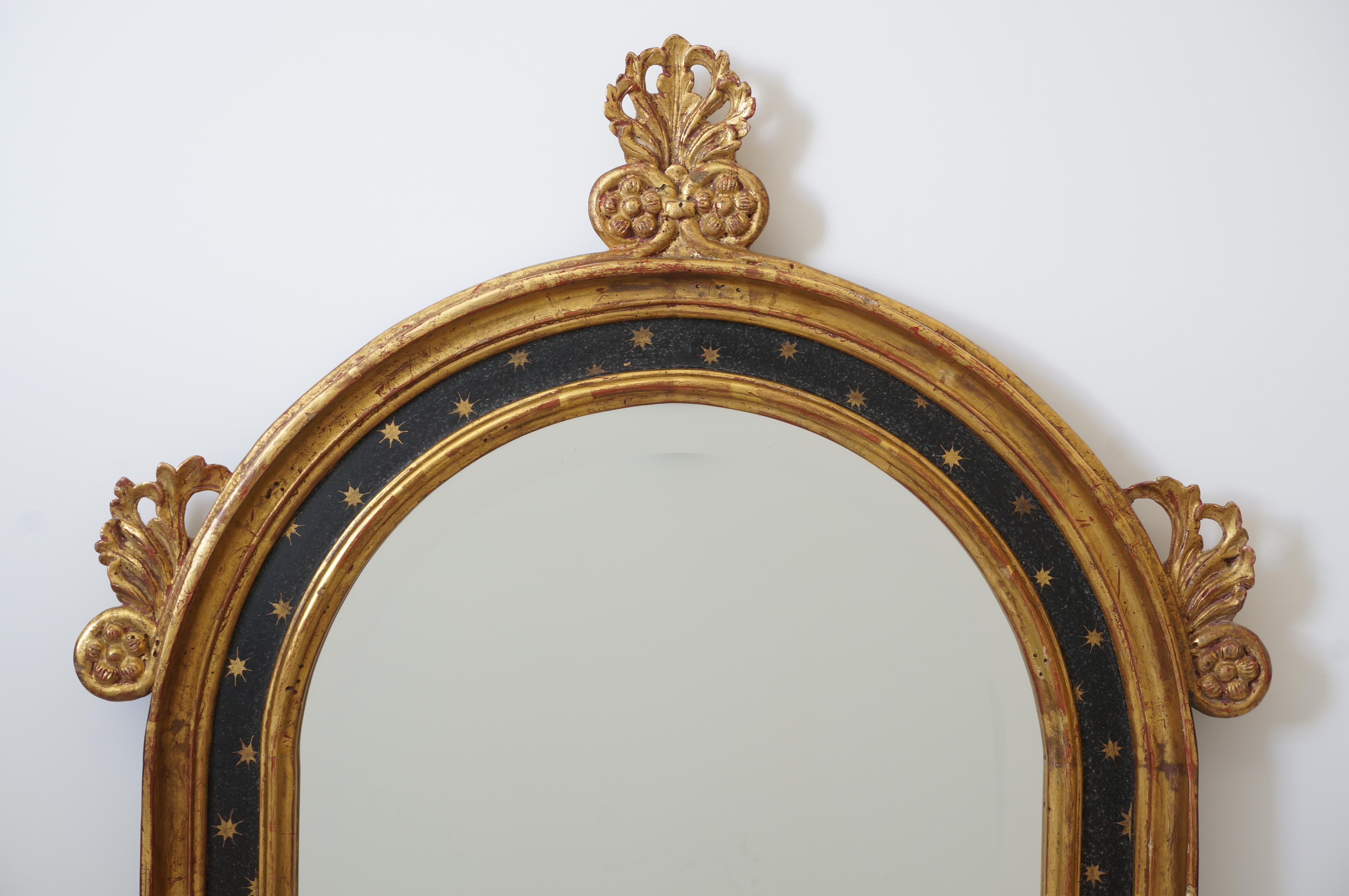 This stylish Italian Renaissance revival style wall mirror with its gold leaf finish and black borders will make a subtle statement with its finish and form.

Note: The Latin text is the beginning lines of the Ave Maria hymn.