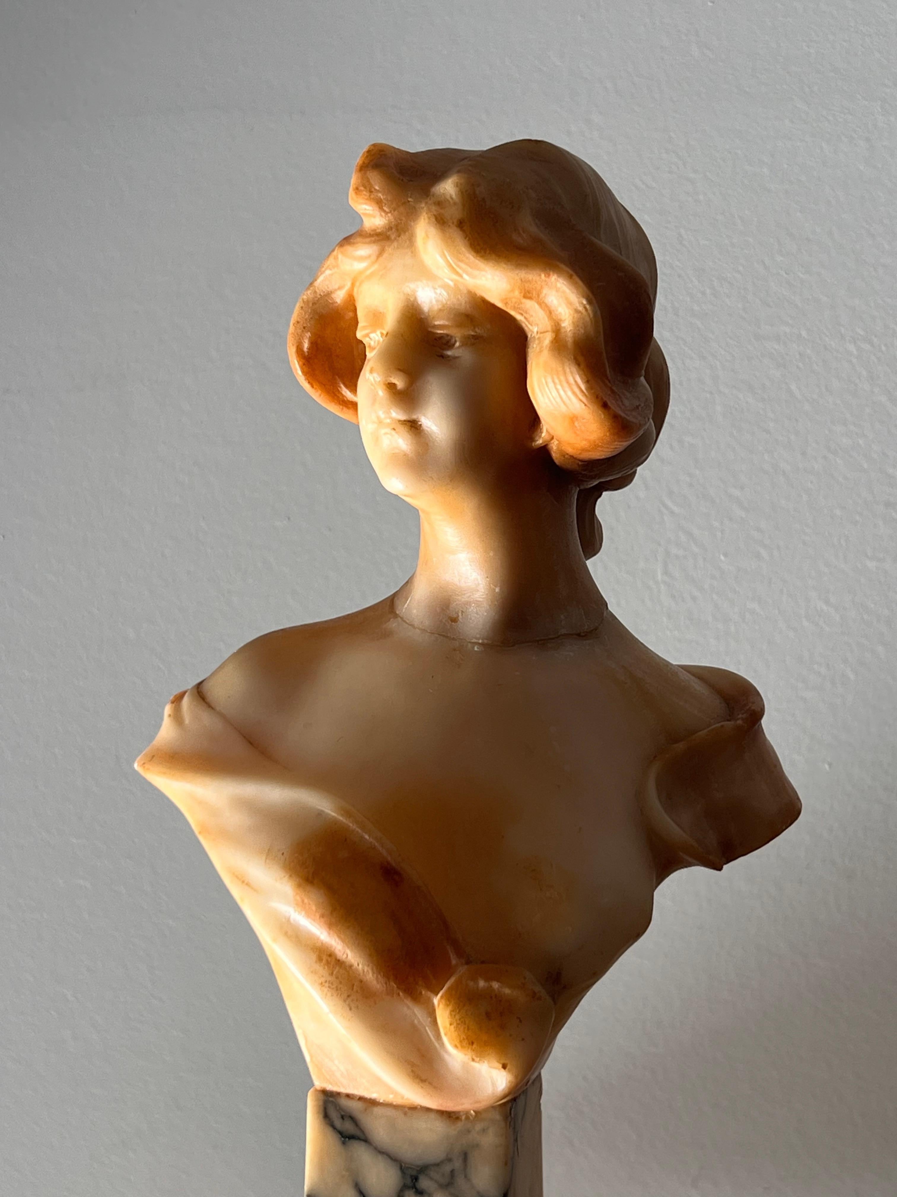 A sculpture of the bust of a woman carved out of alabaster and on a marble plinth, signed by artist, Florence, Italy, 20th century. Elements of rococo and neoclassicism. Please note that she has been repaired; a faint line is visible around the neck