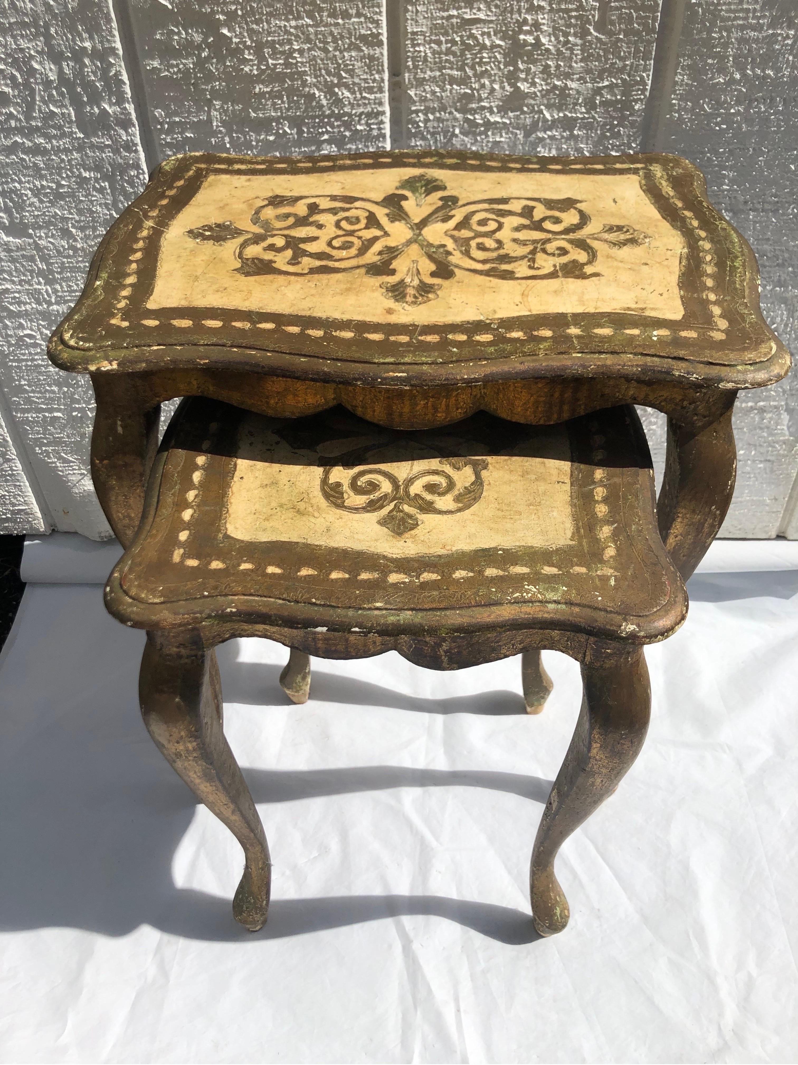 Florentine Nesting Table Set. Two made in Italy matching tables perfectly paired together. Great for that small space. Gold and off white in color. Dimensions for the larger table are : 17.25