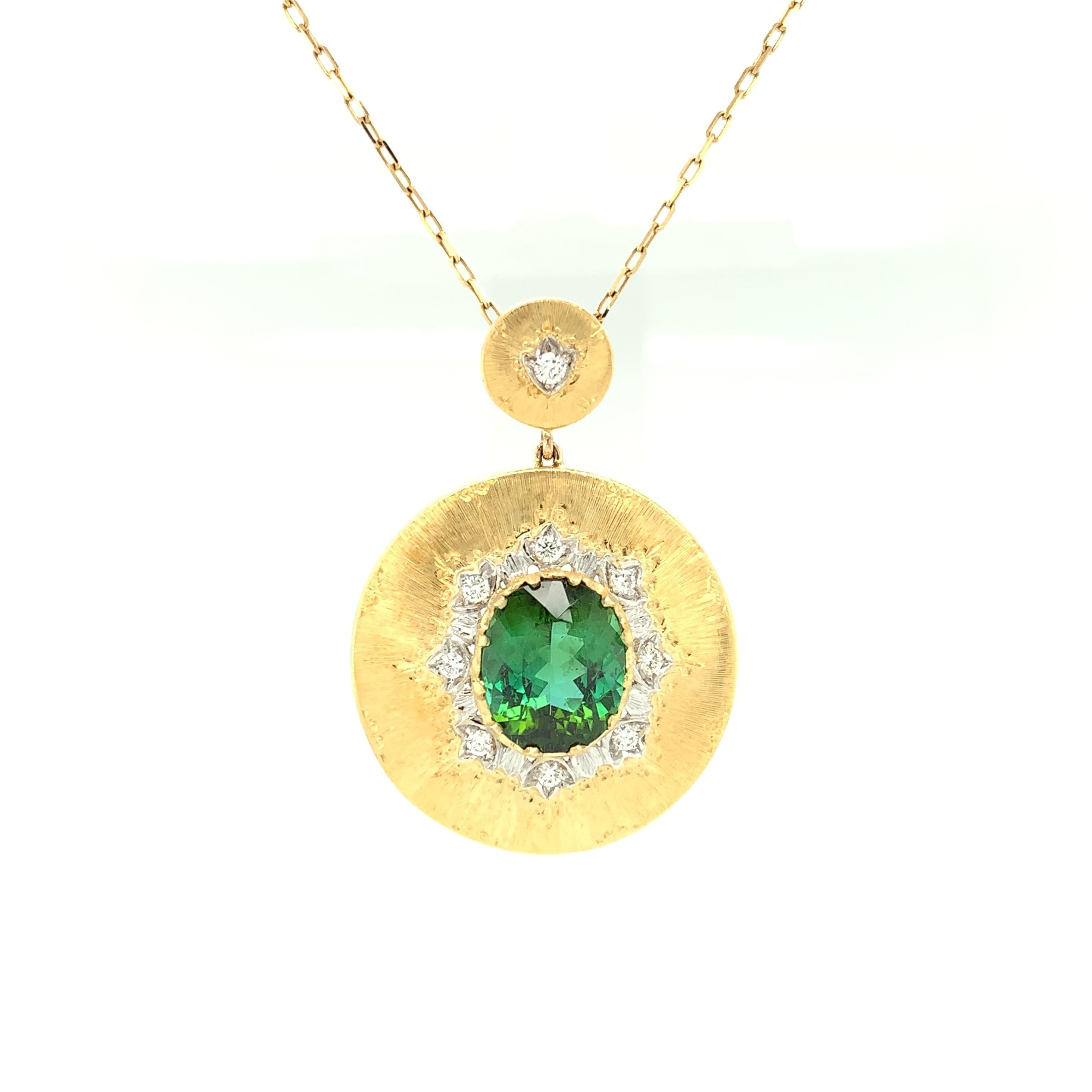 This Florentine style pendant was handmade in Italy and features a 5.79 carat beautiful, deep bluish green tourmaline framed by round brilliant cut white diamonds. The luxurious design and expert craftsmanship of this 18k yellow and white gold