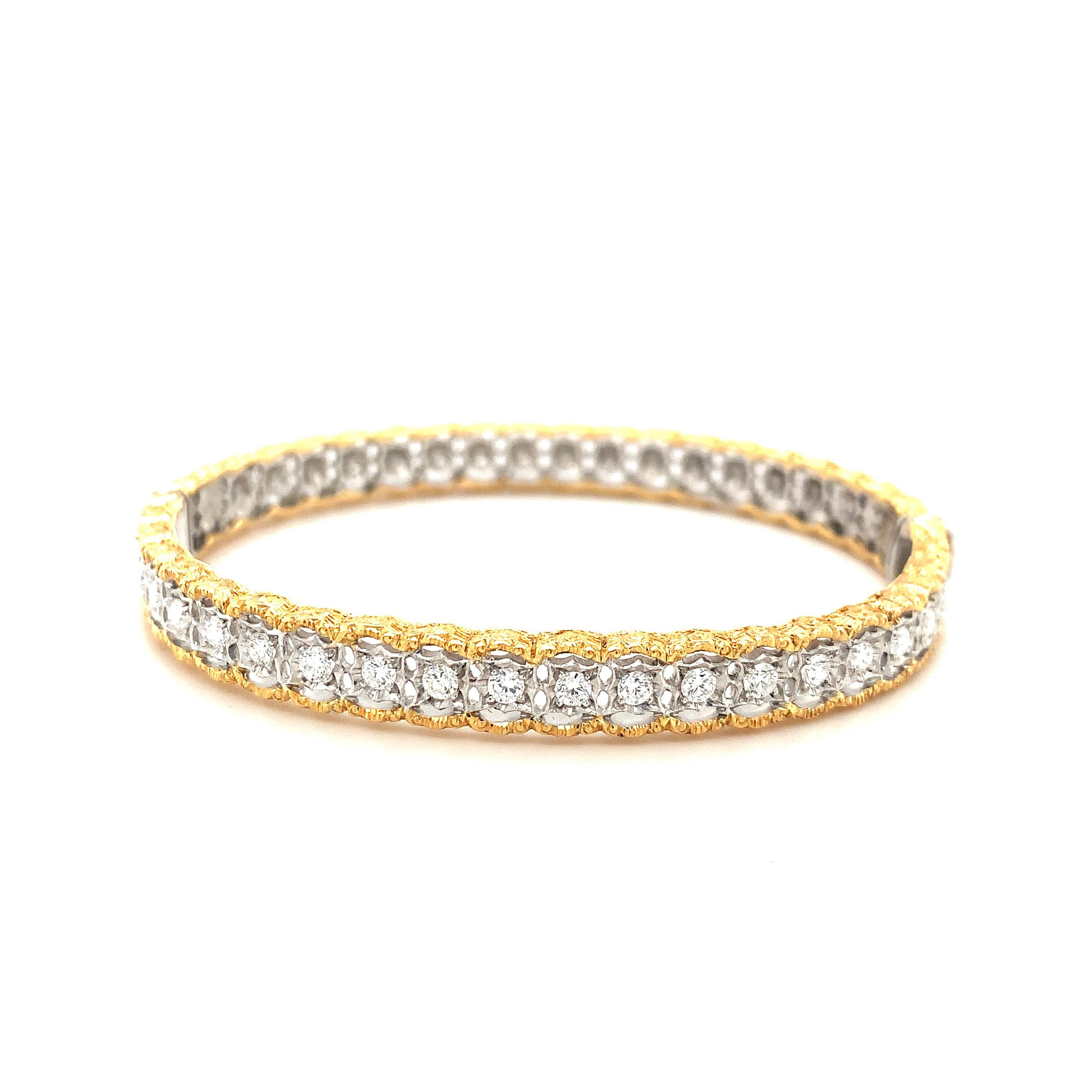 This stunning Florentine style, yellow and white gold bangle bracelet was handcrafted in Italy and is set with a carat of diamonds. The center of the bangle is 18k white gold that has been intricately pierced into individual settings that showcase