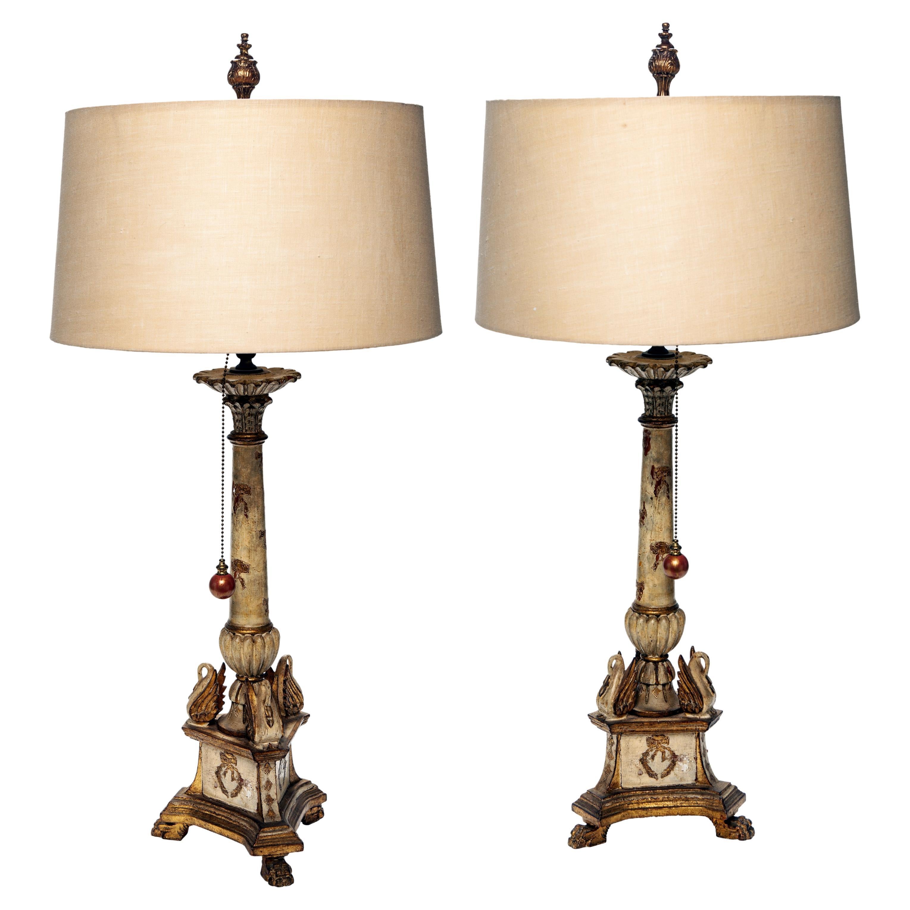 Charming pair of vintage Italian Florentine candlestick lamps with carved wood bases with original painted and gilded finish.
Long beaded brass chain with very user friendly & stylish large bead pulls.
Aged brass casings with new wiring using the