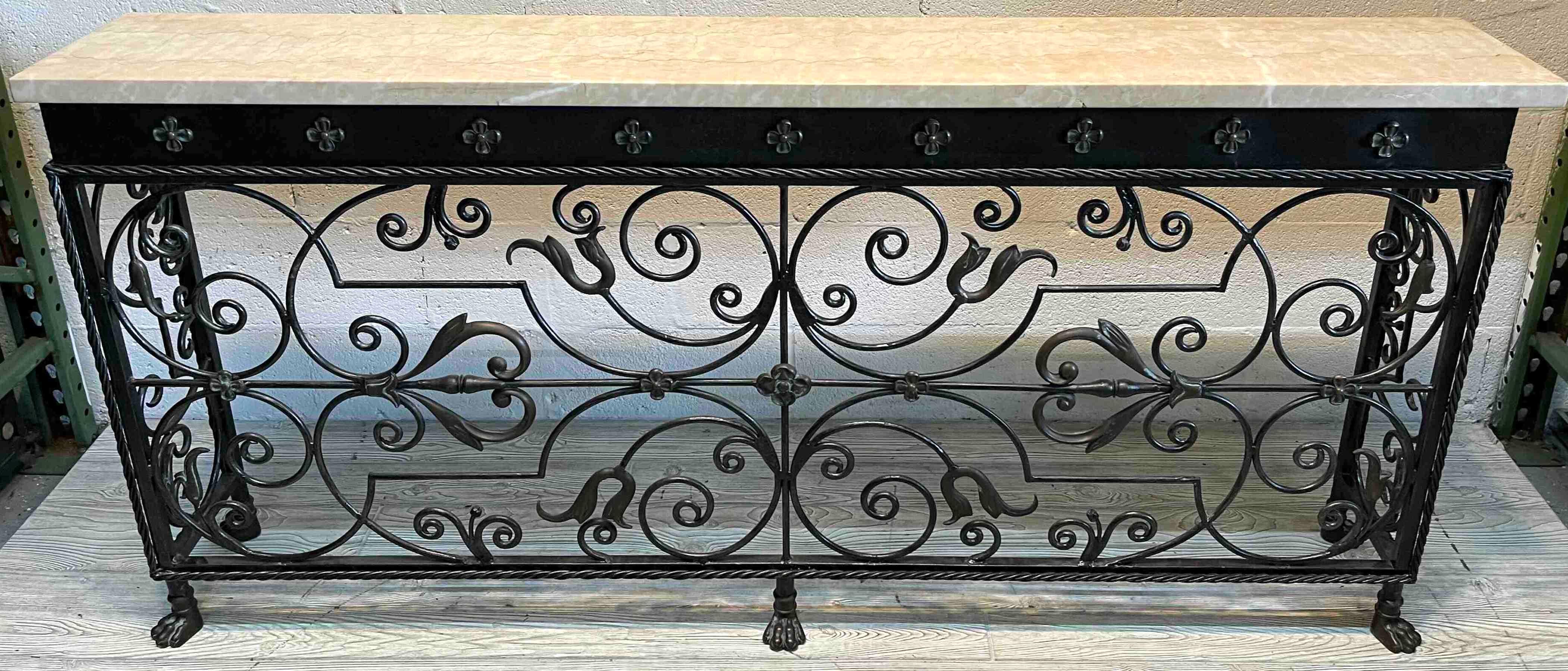 Florentine wrought iron & marble top console, of rectangular form with inset marble top, over flowerhead frieze, with continuous iron work, raised on five paw feet.
  