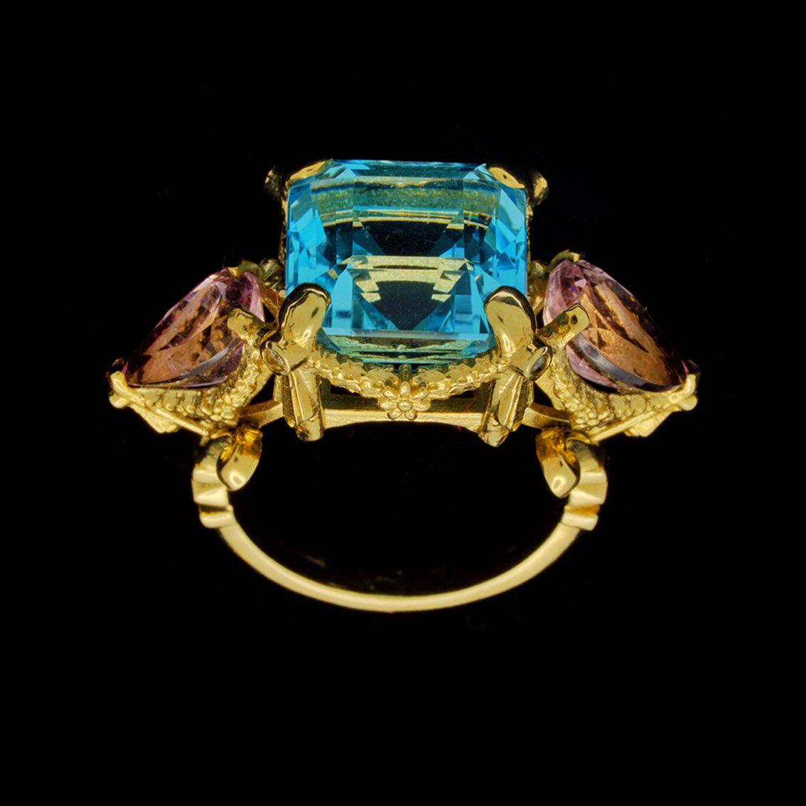 FLORESCENCE GARLAND RING

Intricately handcrafted in 9kt yellow gold this exquisite renaissance inspired ring features a breathtaking sky blue square cut topaz aloft a signature William Llewellyn Griffiths split shank and garland setting decorated