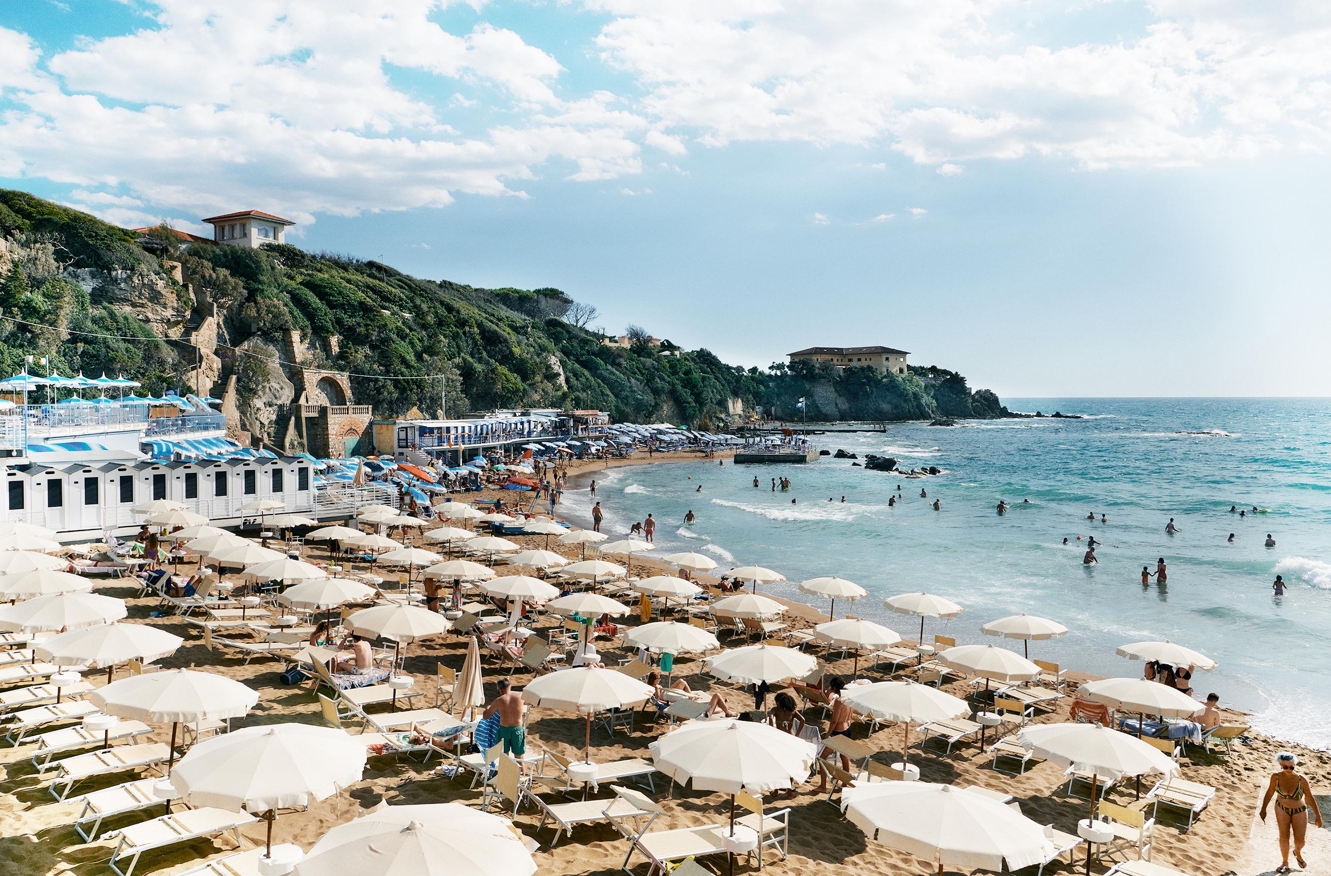 Florian Innerkofler Landscape Photograph - Quercetano Italy Uno- Beach and Sea View with Umbrellas, People, and Mountains