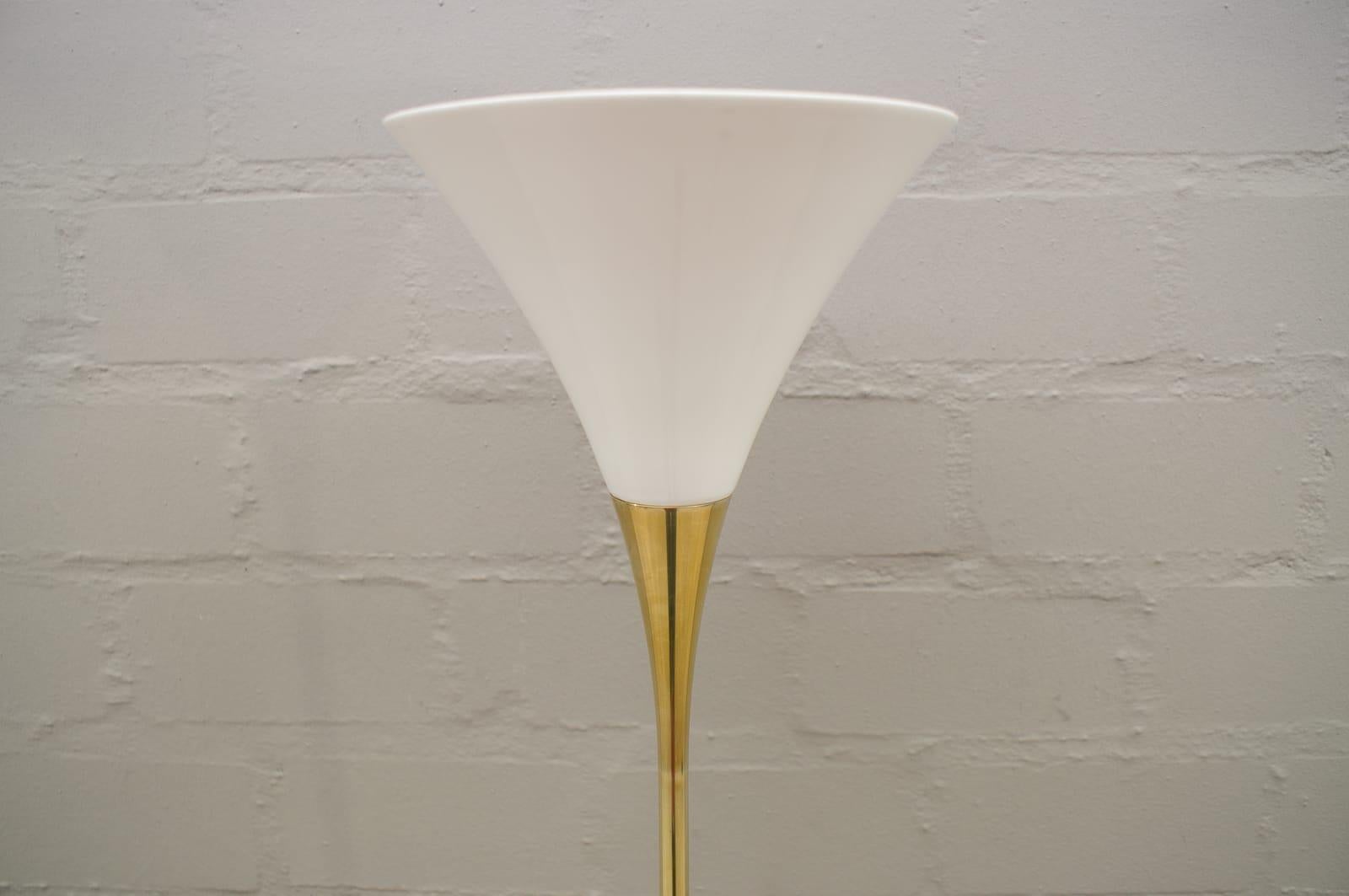Dimensions 
- Total height: 180 cm
- Lampshade (diameter) Ø 23 cm
- Foot (diameter): Ø 26 cm
Material:
- Body:
 Ms: brass polished, lacquered

The Lonea room spotlight by Florian Schulz fascinates with its simple construction, which appears
