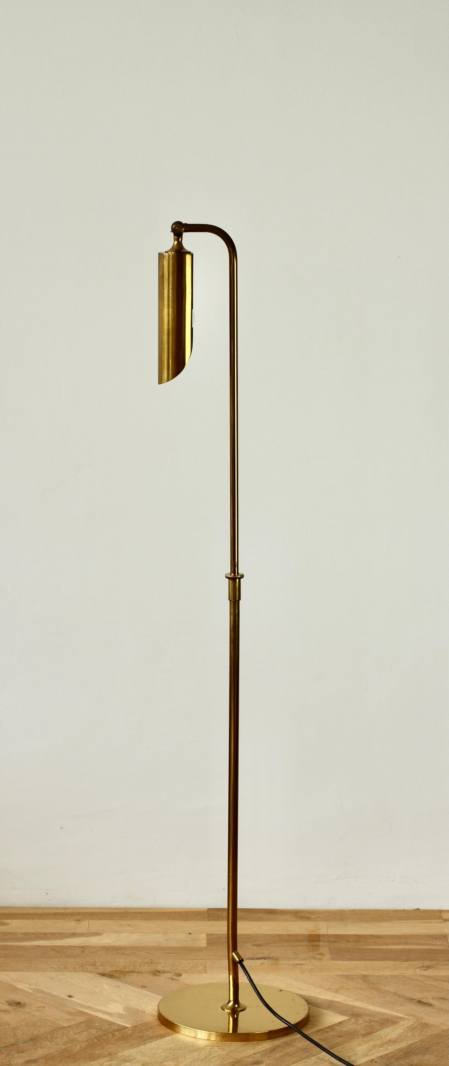 Rare Mid-Century Modern vintage German floor lamp by Florian Schulz circa late 1970s -early 1980s. Featuring polished brass (now with age related patina) and height adjustable as is the round brass shade making this the perfect modernist style