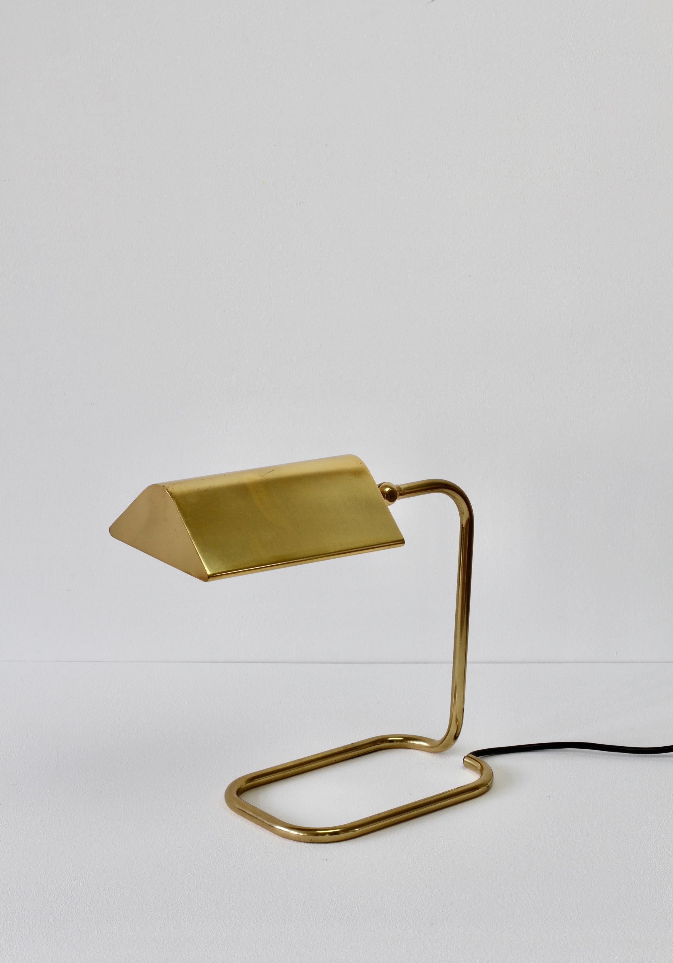 Wonderful Mid-Century Modern vintage German table lamp or desk lamp model 'Cervantes' designed by Florian Schulz in the 1970s. This lamp was made circa 1980s/1990s and was produced by Reim Interline. Featuring lacquered polished brass with