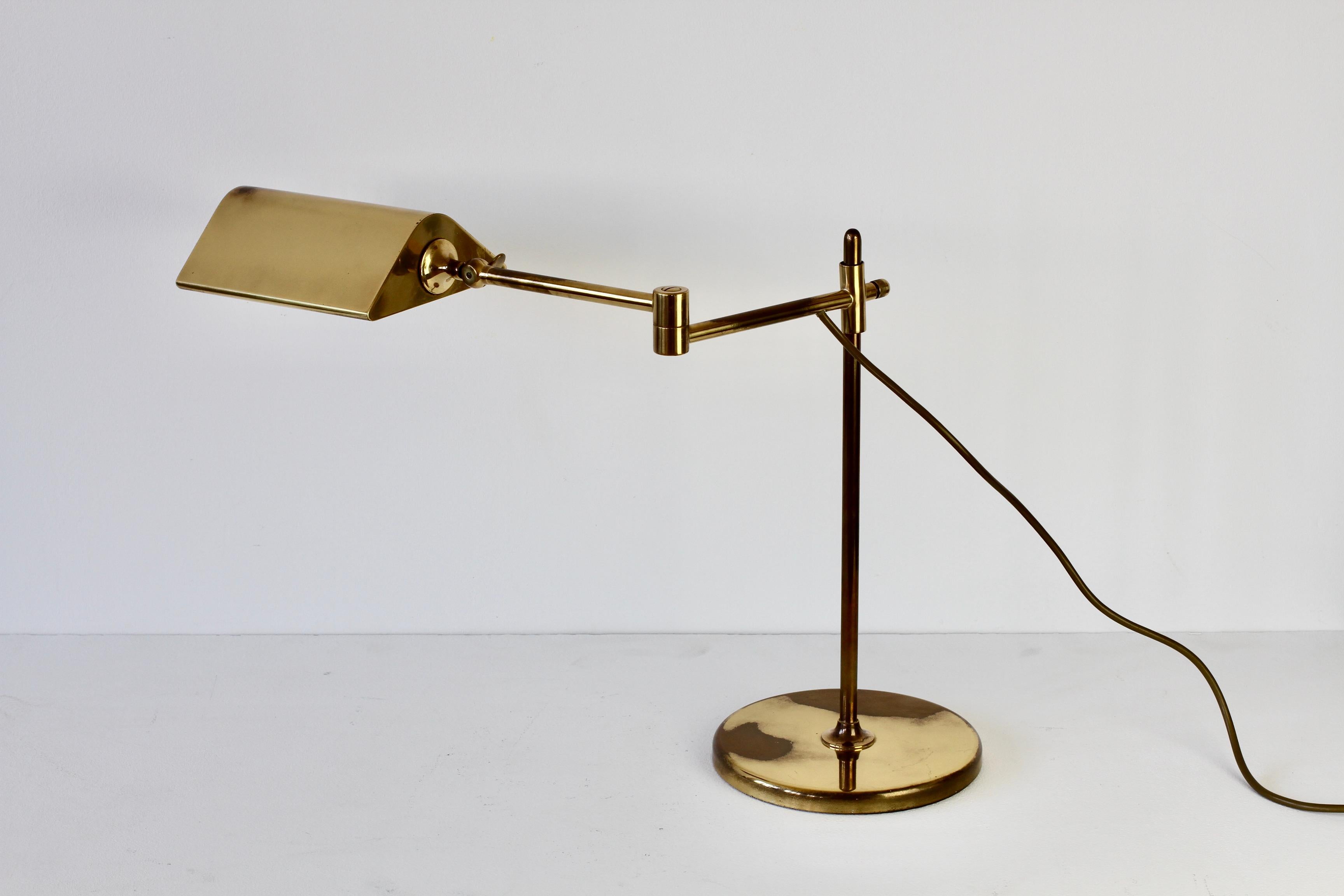 Wonderful Mid-Century Modern vintage German table lamp or desk lamp designed by Florian Schulz in the 1970s. This lamp was made circa 1970s and is quite rare model with the double linked extendable arm which. can be height adjusted on the brass