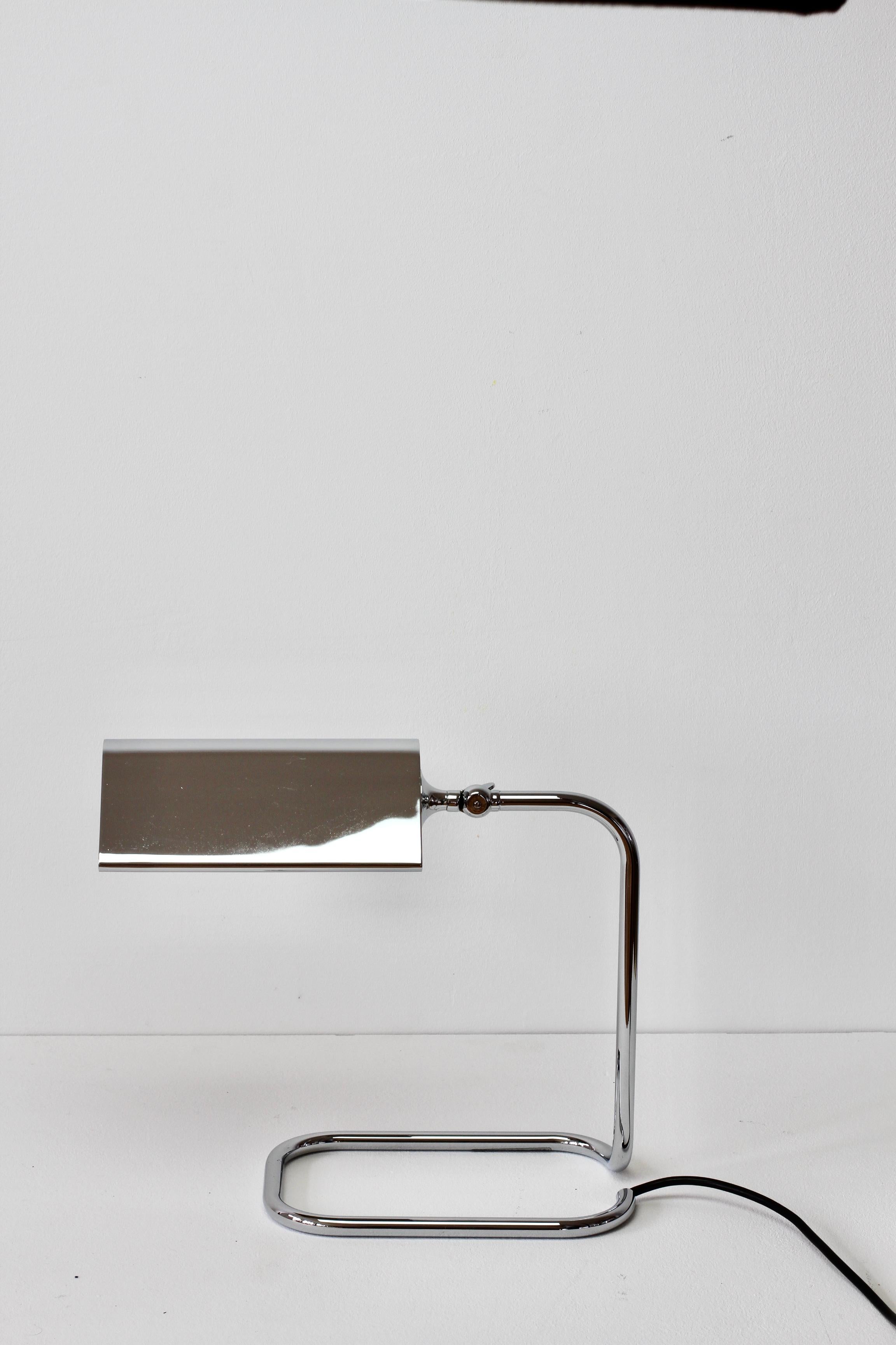Wonderful Mid-Century Modern vintage German table lamp or desk lamp model 'Cervantes' designed by Florian Schulz in the 1970s. This lamp was made circa 1990s and was produced by Reim Interline. Featuring lacquered polished chrome with adjustable
