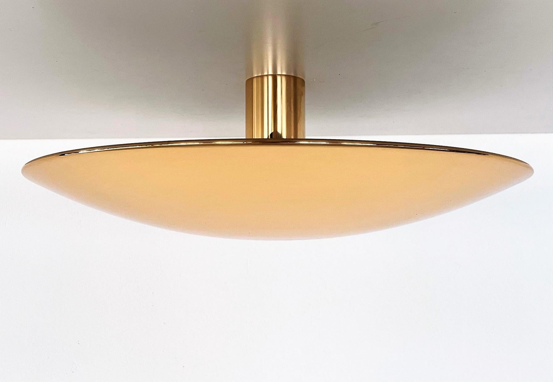 Magnificent, large version of flush-mount light or wall sconce made of full brass by Florian Schulz.
The large round dome plate is screwed on the wall or ceiling unit, which holds five Edison light bulbs.
The full polished brass is very shiny and in