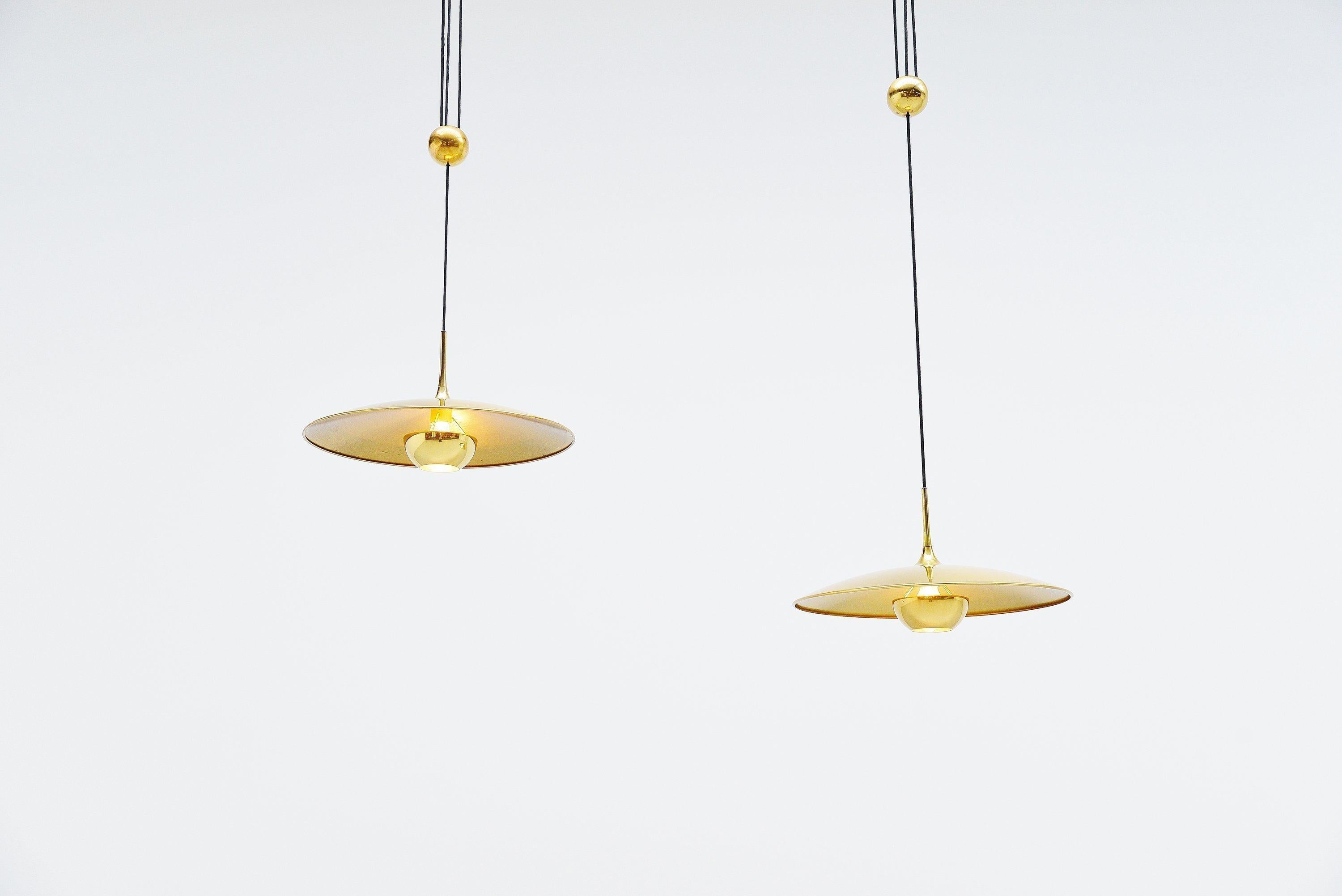 Stunning pair of Onos 55 balance lamps designed and manufactured by Florian Schulz, Germany, 1955. These super quality balance lamps have a heavy weighted round ball in the middle which makes it possible to easily change the height of these lamps.