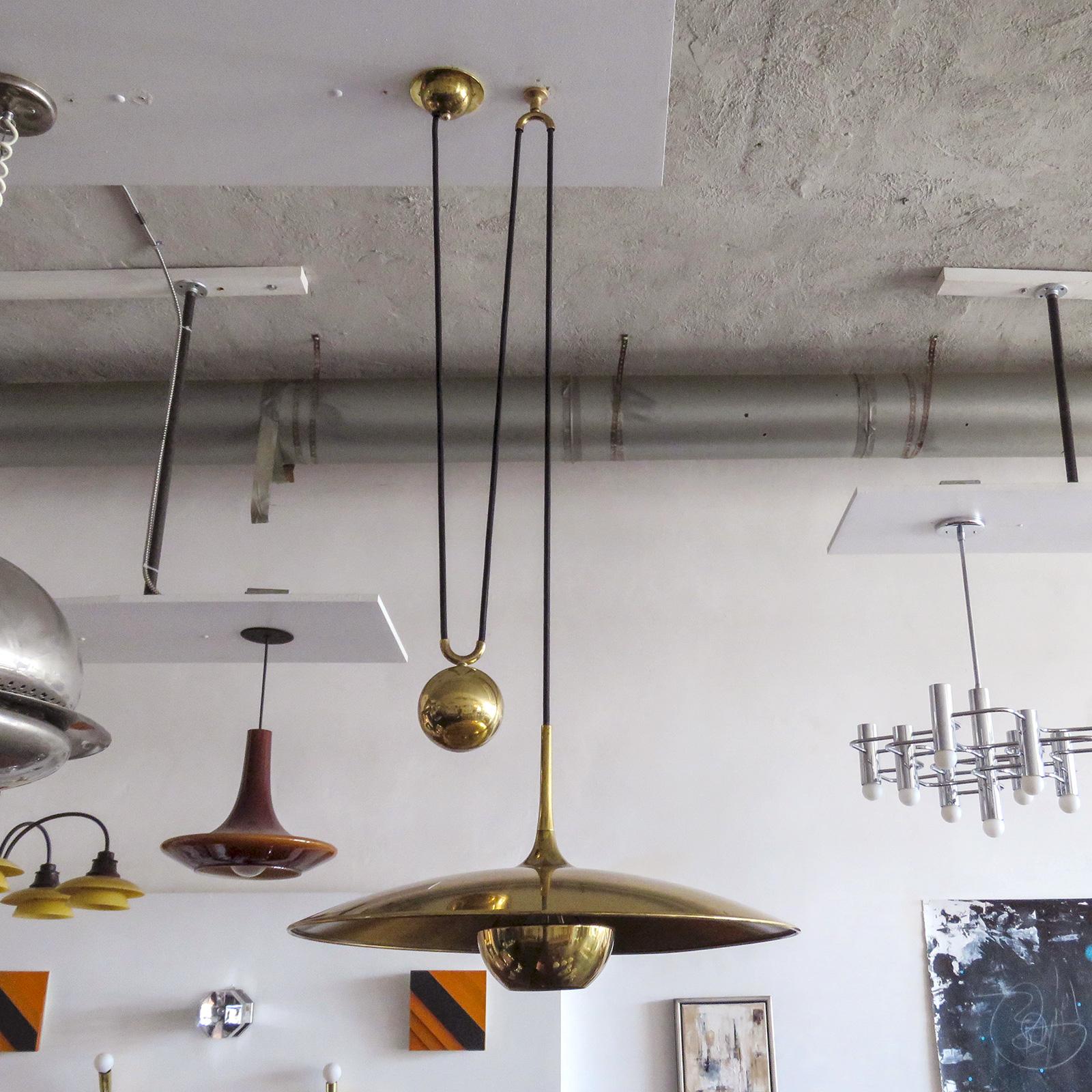 Wonderful large brass saucer pendant by Florian Schulz, Germany, with very heavy solid brass sphere counterweight pulley mechanism, current extension capability from 12