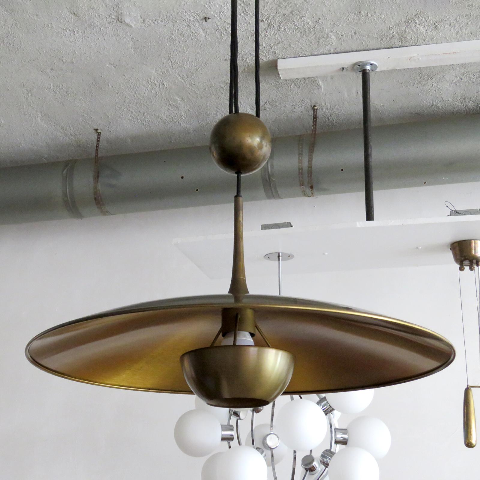 Wonderful large brass saucer pendant by Florian Schulz with central pulley mechanism, a heavy brass ball counter balances the weight of the fully adjustable shade.
