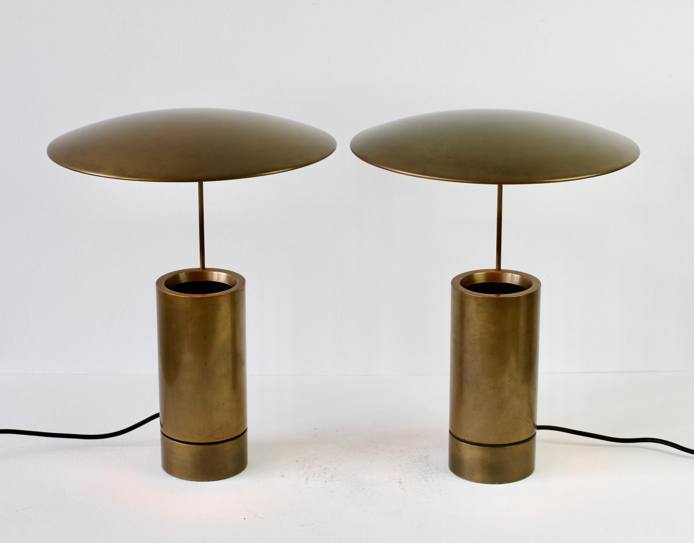 Incredibly rare and hard to come by pair of vintage Mid-Century Modern German made side table lamps or desk lights by Florian Schulz circa late 1980s - late 2000s. Featuring a matt brushed brass finish and ingeniously designed round adjustable