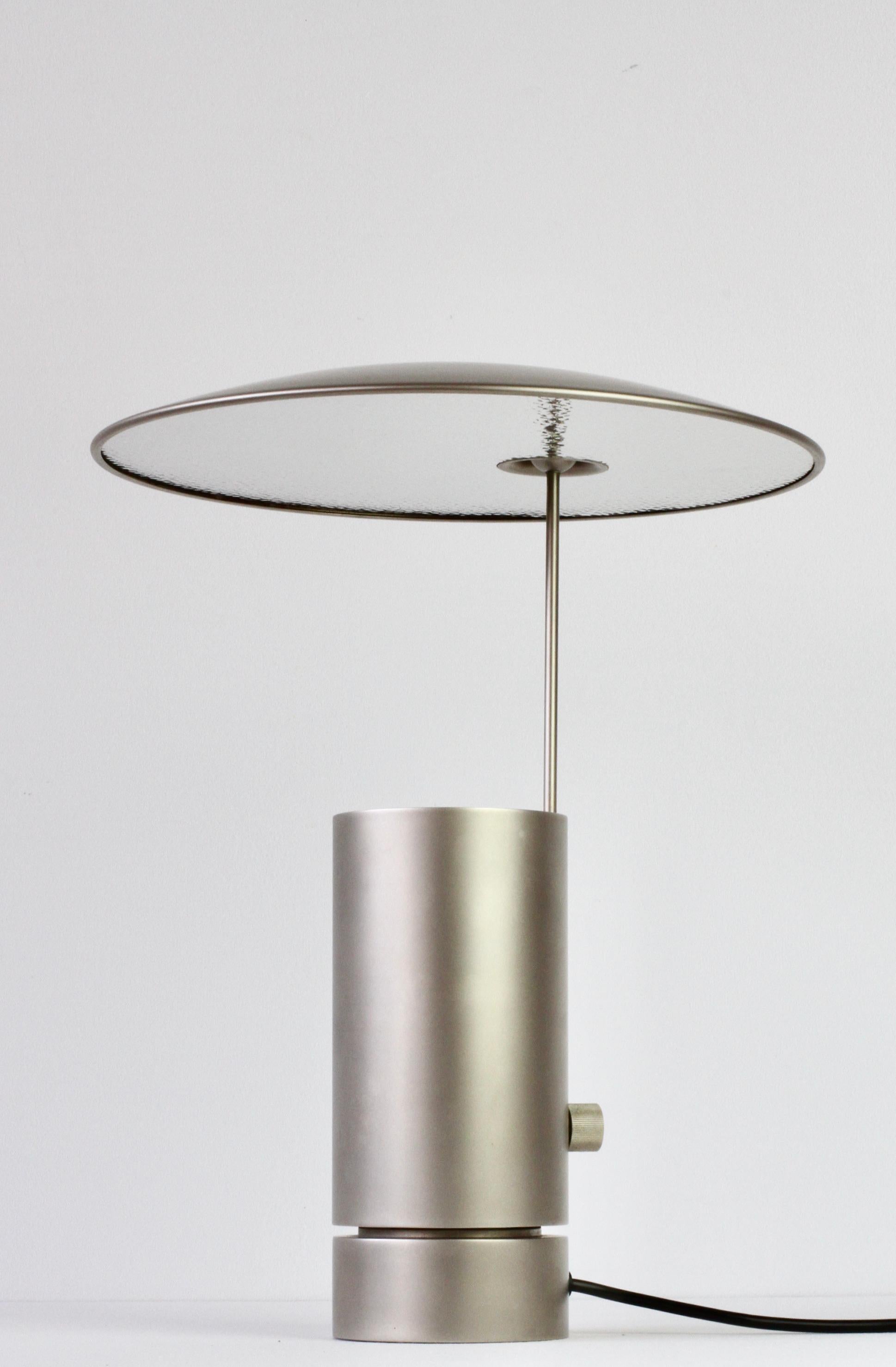 Incredibly rare and hard to come by vintage Mid-Century Modern German made side table lamp or desk light by Florian Schulz circa 1990s - late 2000s. Featuring a satin matt brushed nickel finish and an ingeniously designed round adjustable shade