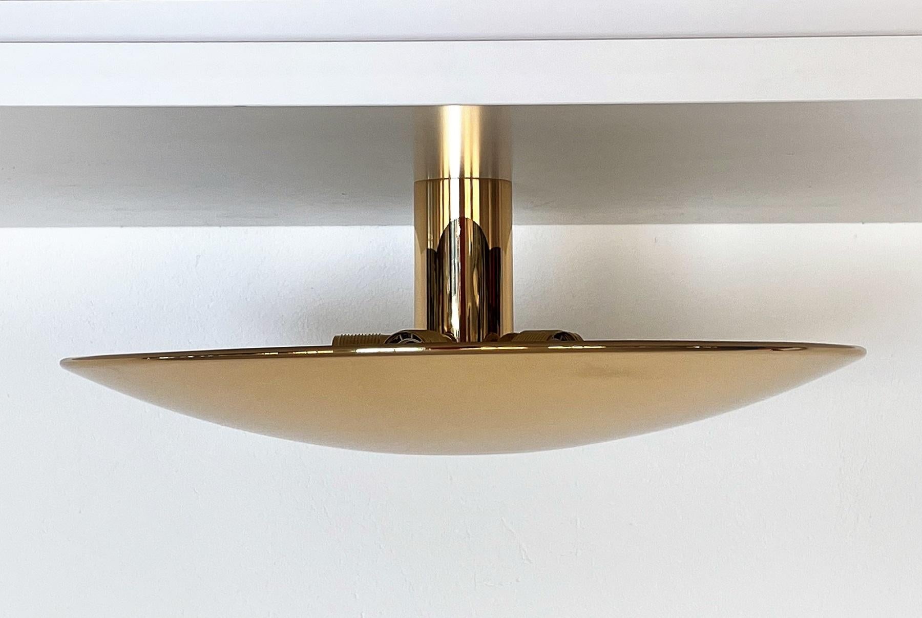 Magnificent, large version of flush-mount light or wall sconce made of full polished shiny brass by Florian Schulz.
The large round dome plate is screwed on the wall or ceiling unit, which holds five Edison light bulbs.
The full polished brass is