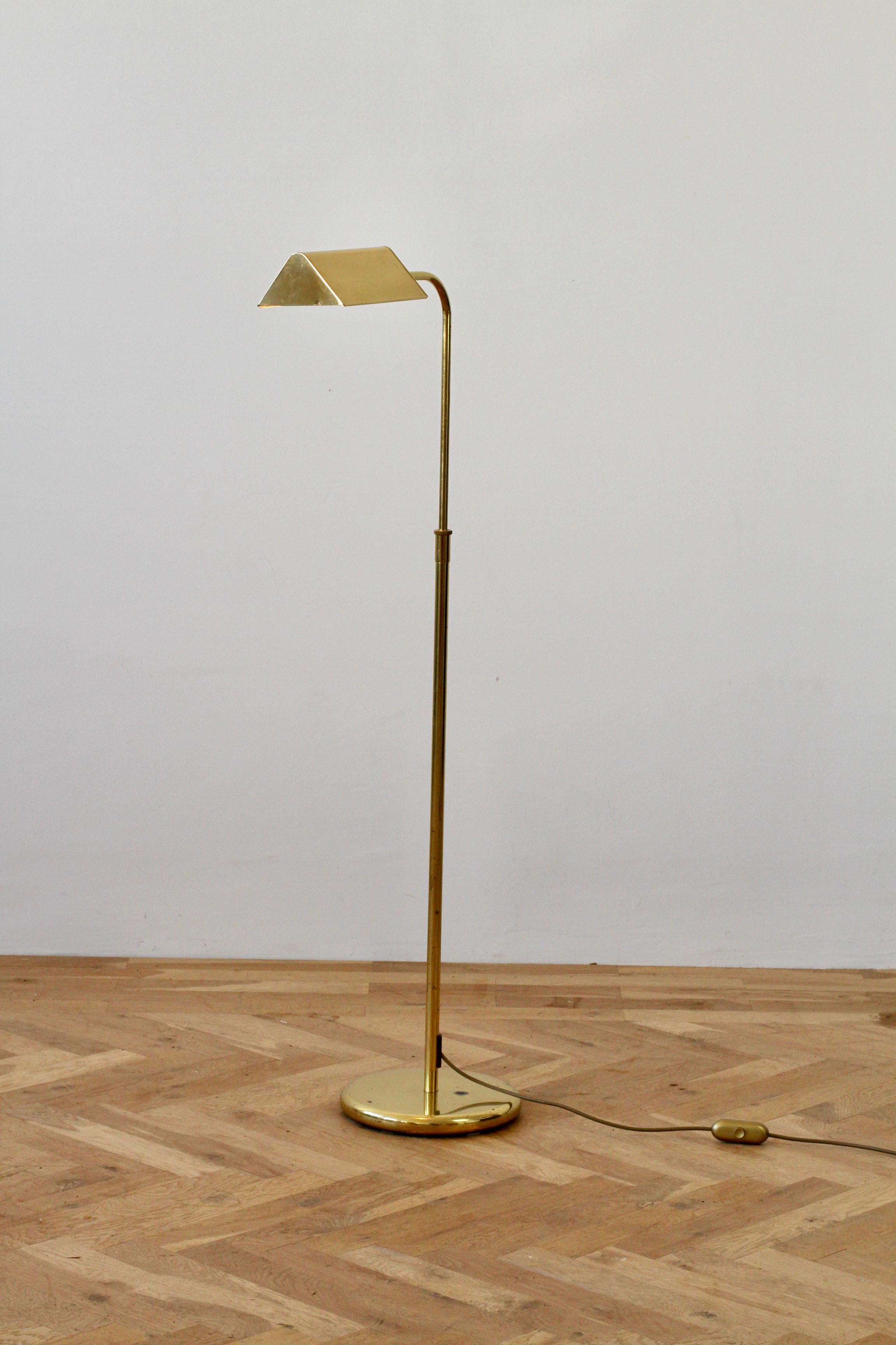 Florian Schulz style Mid-Century Modern vintage German made adjustable reading light or floor lamp by Sölken Leuchten circa late 1970s - early 1980s. Featuring polished brass (now with age related patina) and height adjustable as is the brass shade