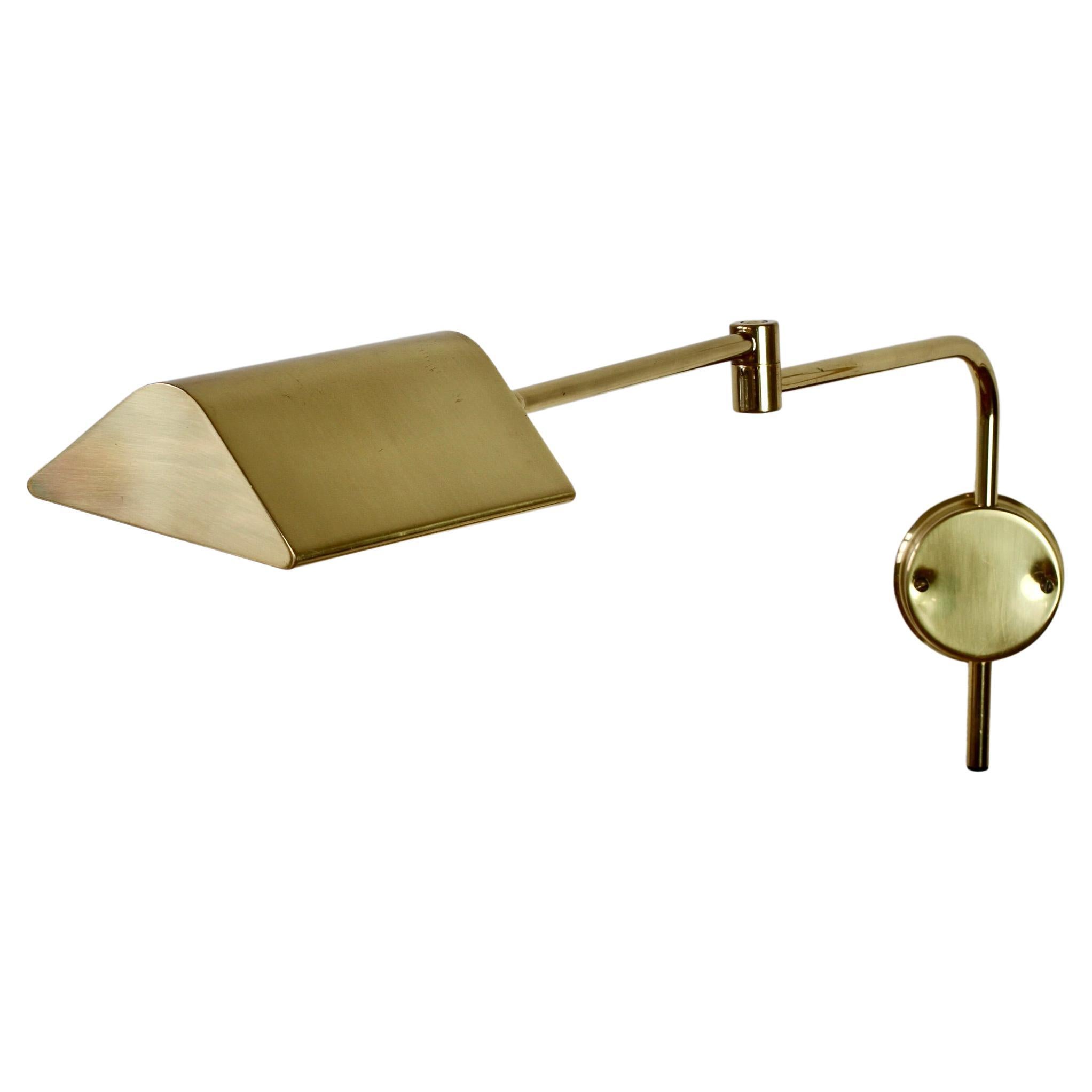 Rare Mid-Century Modern vintage German adjustable wall mounted reading lamp, light or sconce by Florian Schulz circa late 1970s -early 1980s. Featuring polished brass (now with age related patina) and fully adjustable lampshade and pivoting arm