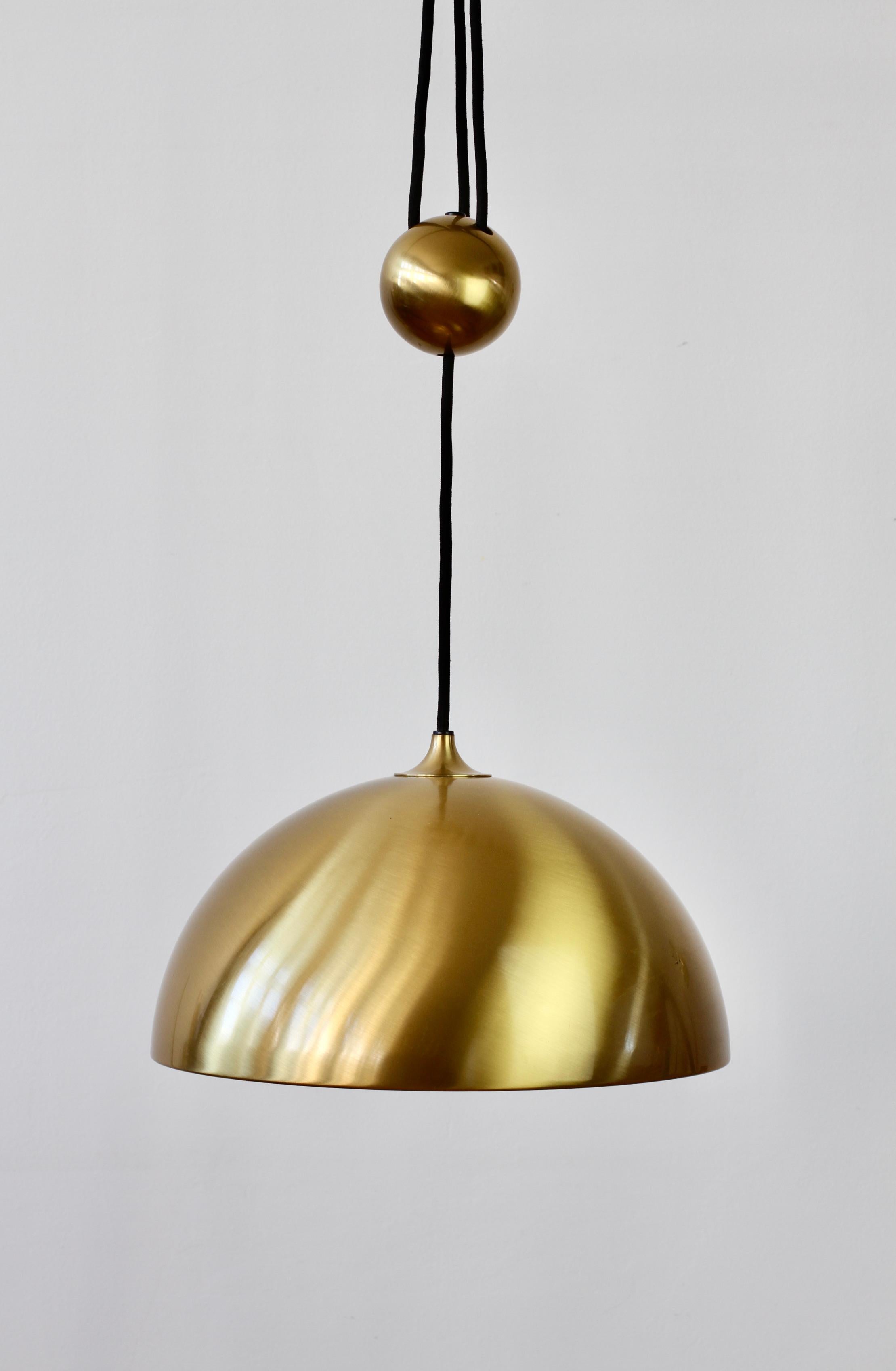 Elegant Mid-Century Modern vintage German made large brushed brass adjustable counterweight hanging pendant light or lamp model 'Duos' designed by Florian Schulz circa early 1970s. Featuring brushed lacquered brass and is height adjustable via the