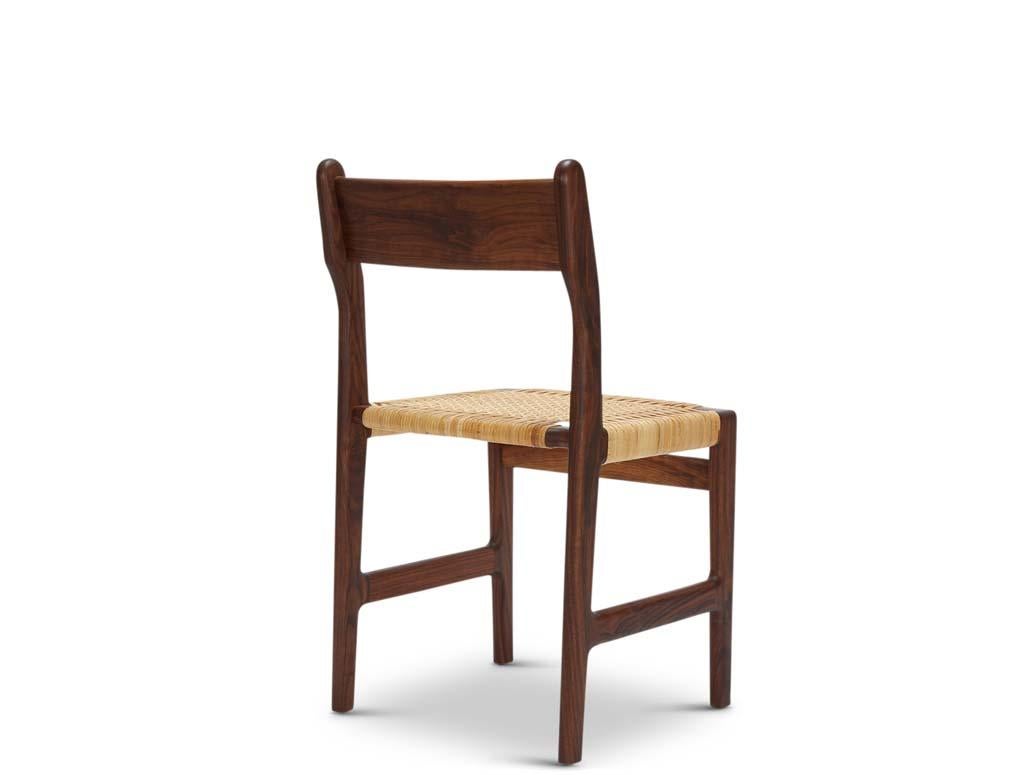 Floriano Caned Dining Chair. Inspired by Scandinavian mid century design, the Floriano Caned Dining Chair has a wooden frame that contracts and expands to highlight a subtly curved back. Available in handwoven cane or supple leather, the chair feels