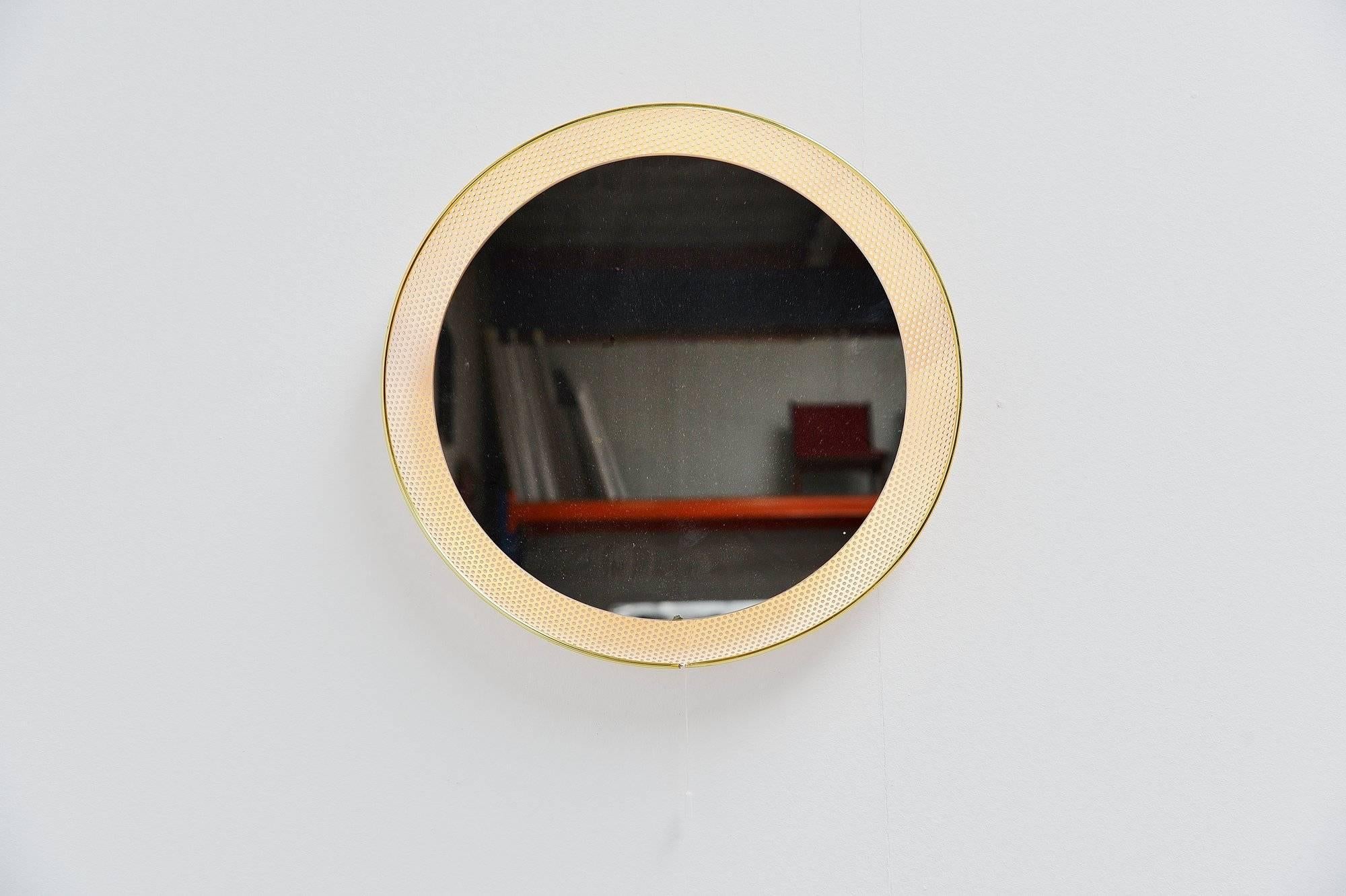 Very nice and decorative round illuminated wall mirror designed by Floris Fiedeldij made by Artimeta Soest, Holland, 1960. These mirrors are often sold or attributed as Mathieu Mategot mirrors. This is a white painted mirror, fully die cut back.