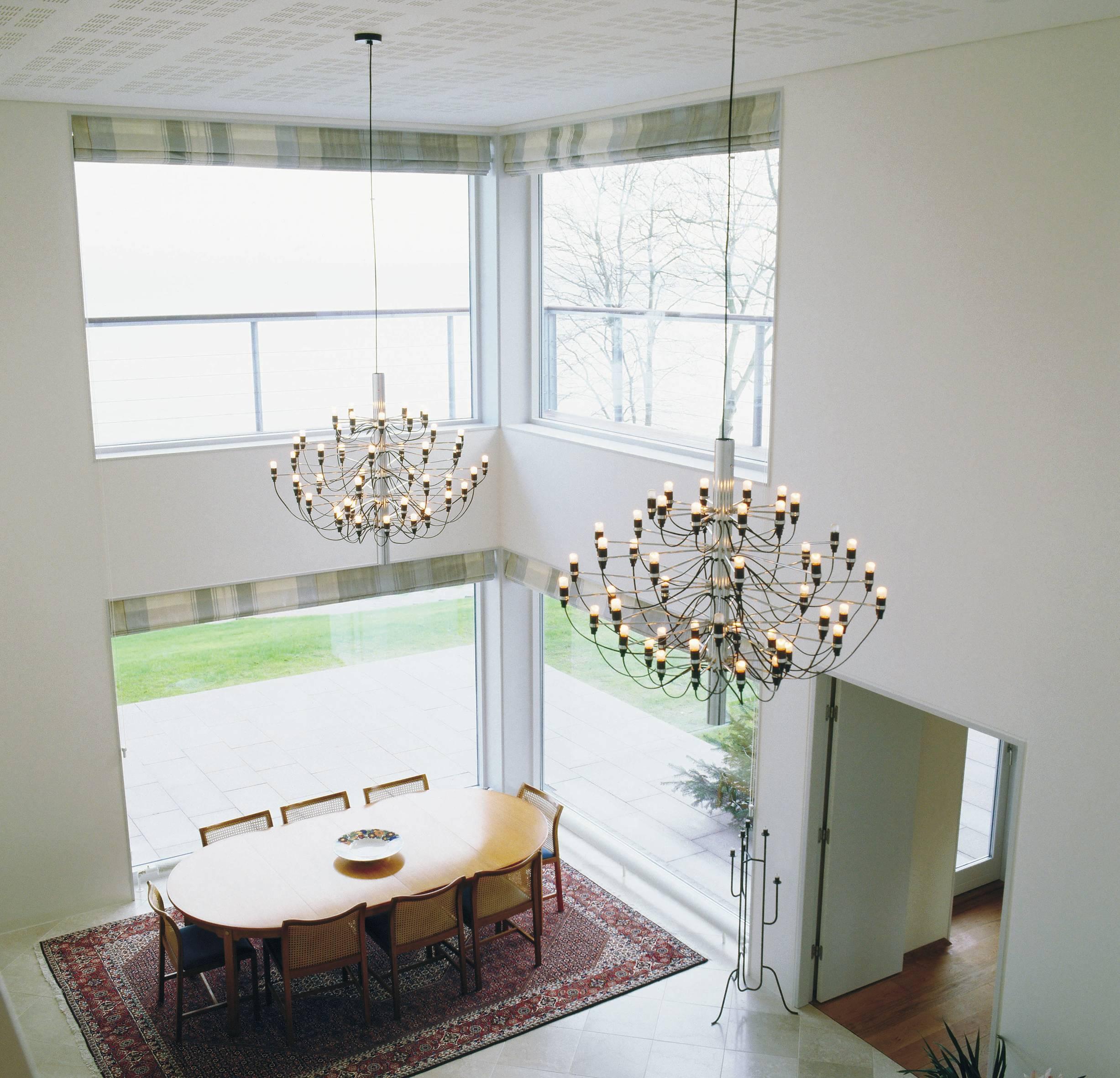 Since 1958, this iconic Gino Sarfatti design has served as an ultra-modern representation of the traditional midcentury chandelier. Every detail of this state-of-the-art ceiling light is exceptional, from the mirror-polish finish of its main steel