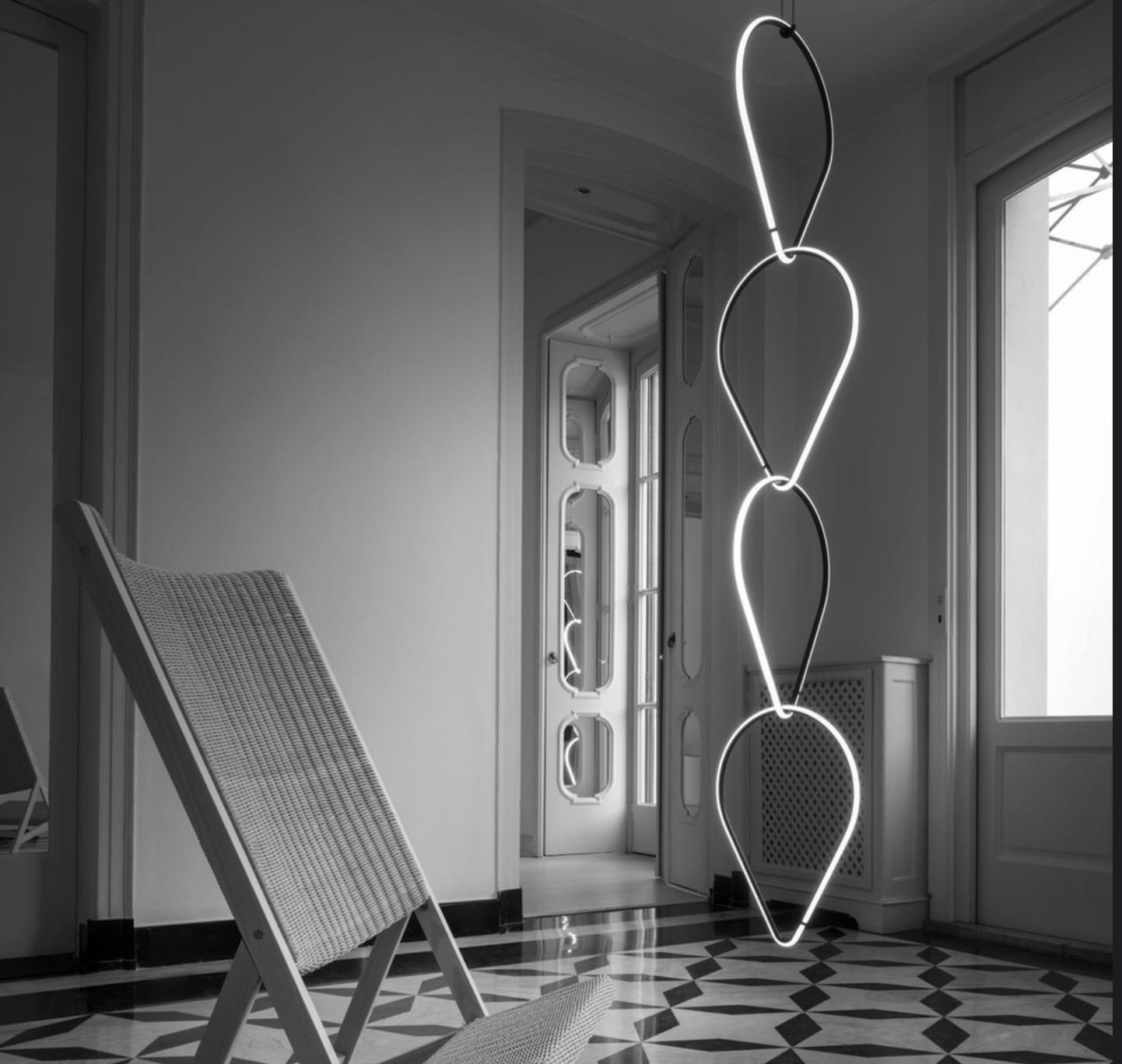 Flos Arrangements pendant chandelier modular quadruple drop-down light sculpture.

Designed by Michael Anastassiades, Arrangements is a modular system of geometric light 'elements that can be combined in different ways, creating multiple