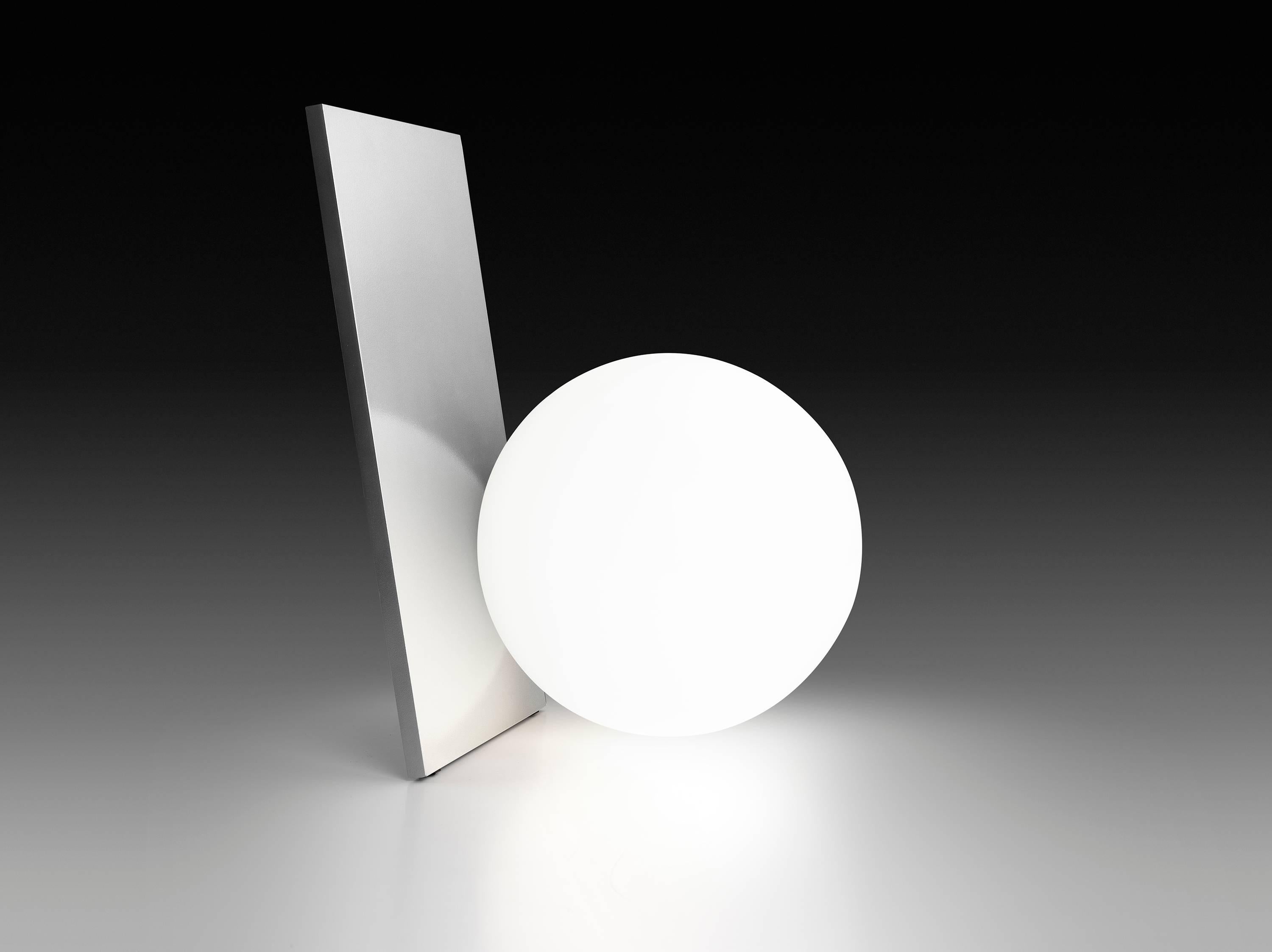 This graceful table lamp provides a soft and beautiful diffused glow through an elegant orb that is brilliantly balanced against its sleek body. It is available with a body of painted or anodized aluminum made by CNC matching. It features a